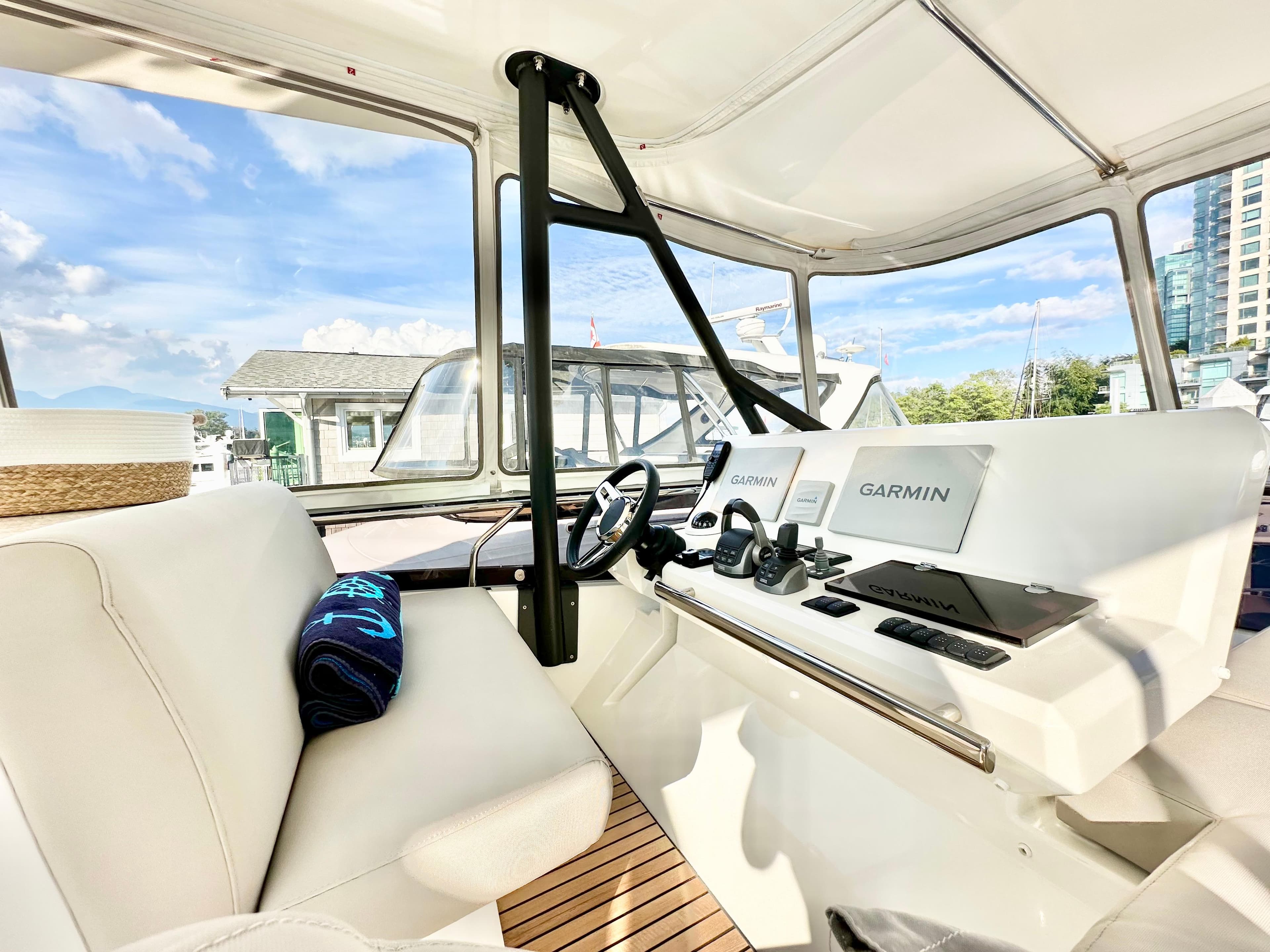 Interior of 2023 Prestige 520 yacht with modern navigation equipment and luxurious seating.