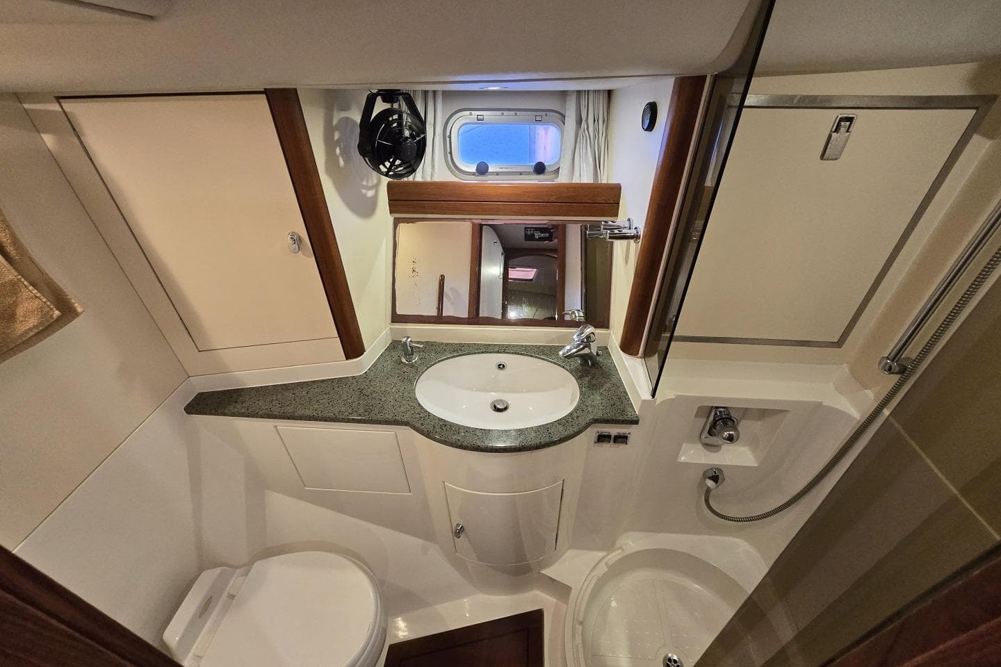 Luxurious bathroom interior of a 2005 Oyster 56 yacht, featuring modern fixtures and compact design.