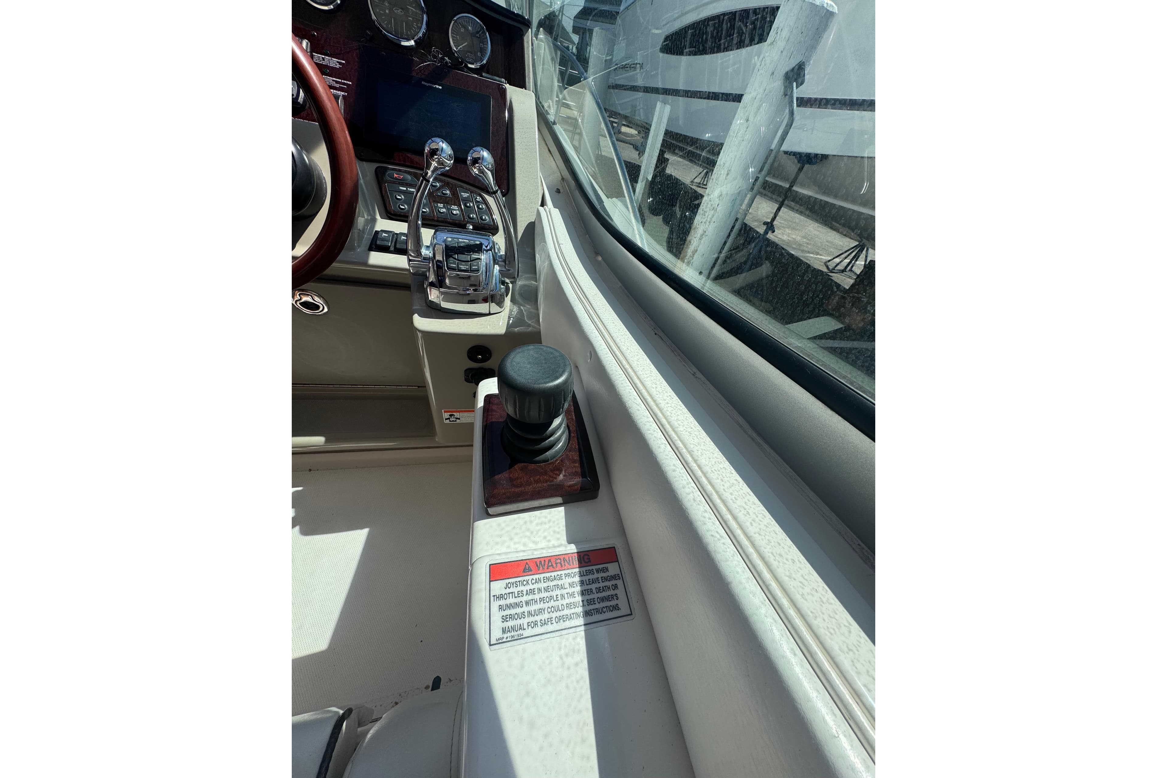 2010 Searay 330 Sundancer helm with controls and warning label, showcasing dashboard details.