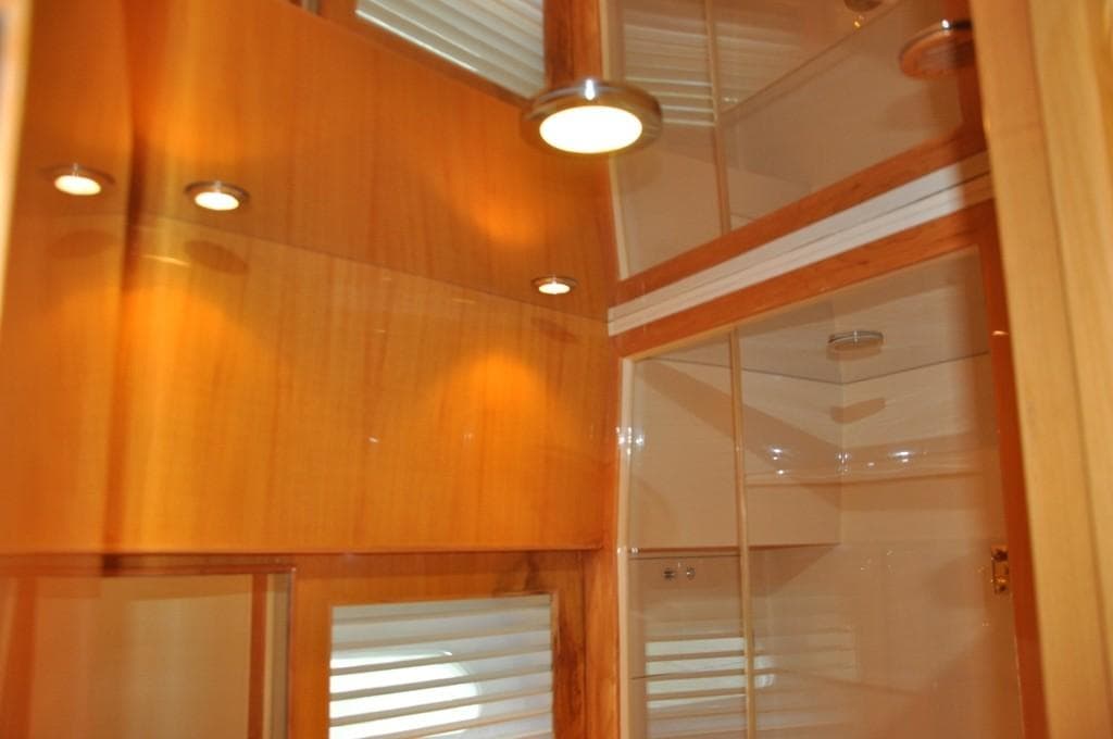 Interior of 2003 McKinna 58 yacht with wooden paneling and recessed lighting.