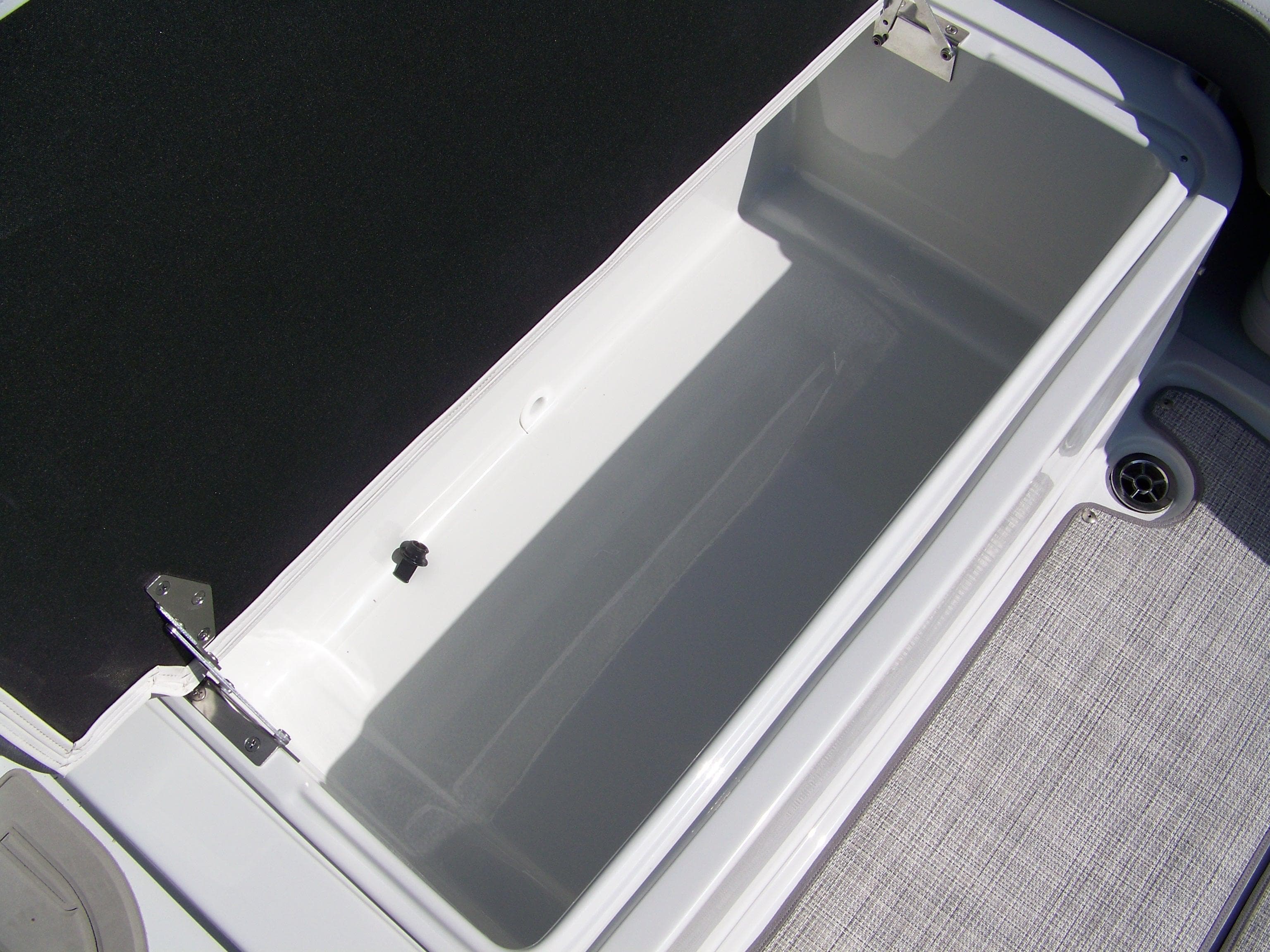 2026 Crownline Eclipse E210 XS boat storage compartment, open and empty.