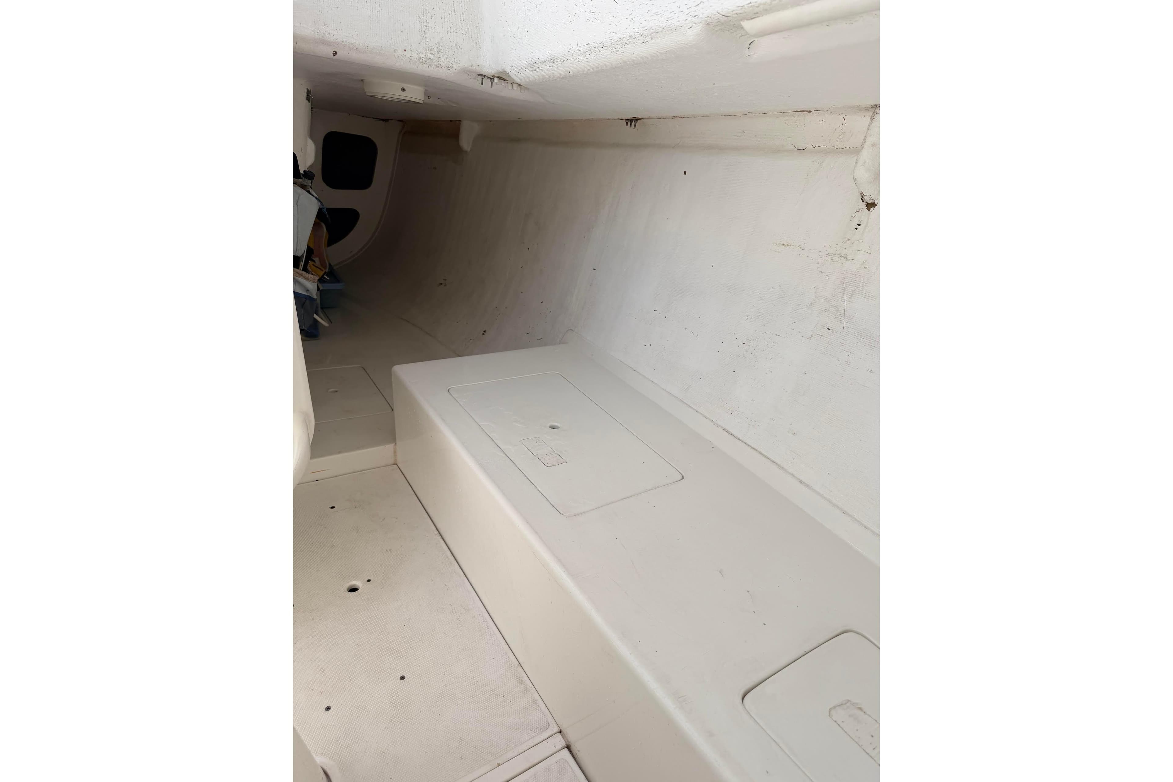 Interior of a 2007 Flying Tiger 10M sailboat, featuring a minimalist white cabin design.