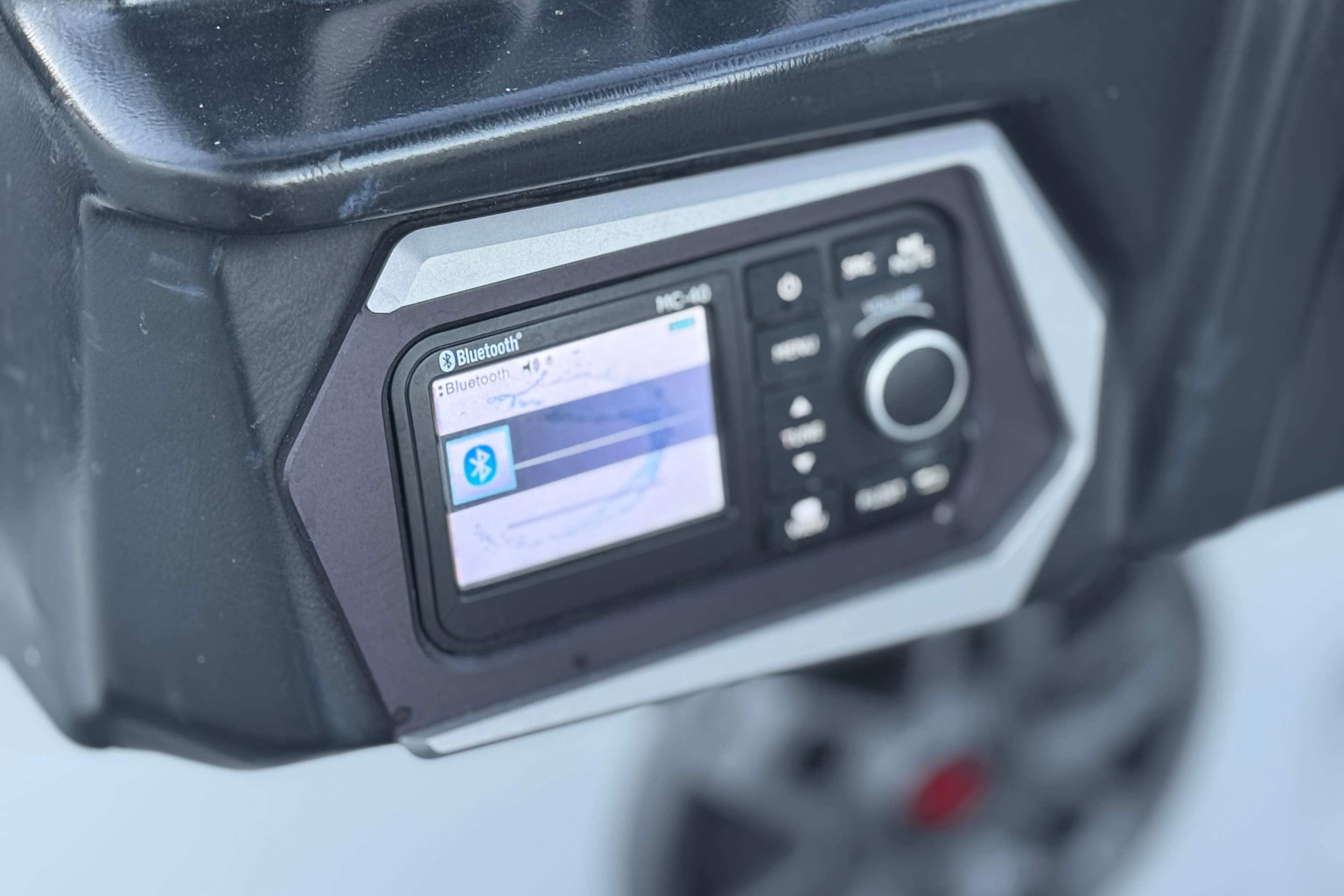 Close-up of 2023 Axis T220 Bluetooth control panel with display screen.
