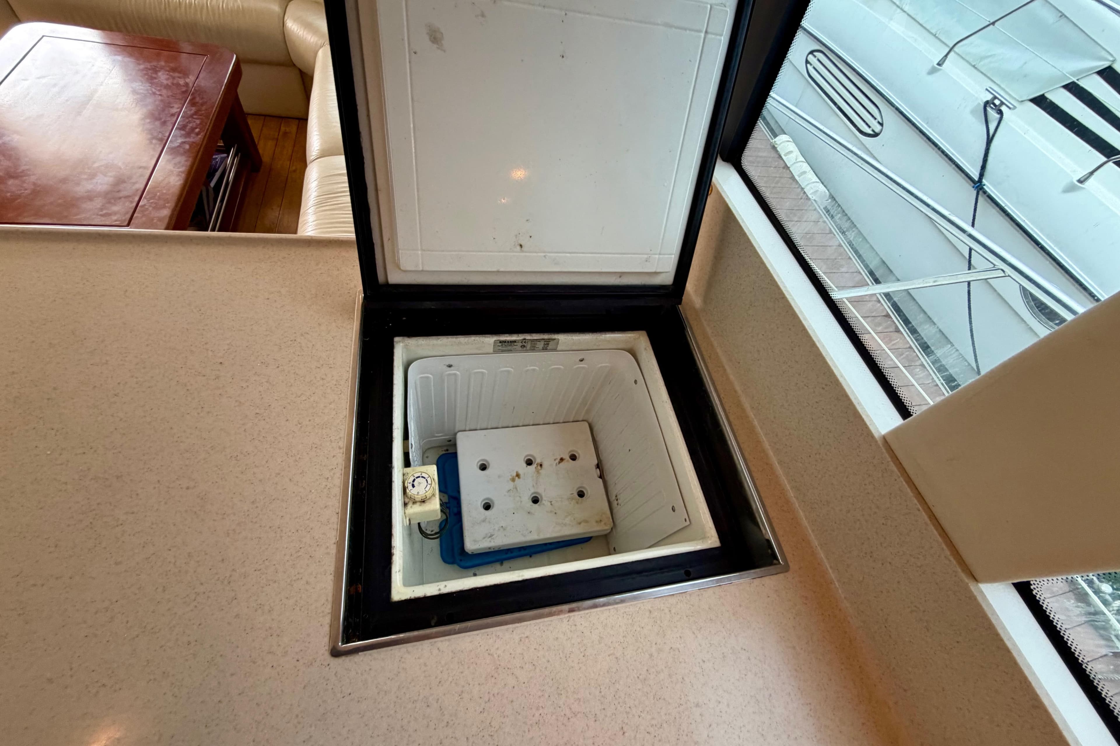 Open storage compartment on 2003 Riviera 60 Flybridge yacht interior.