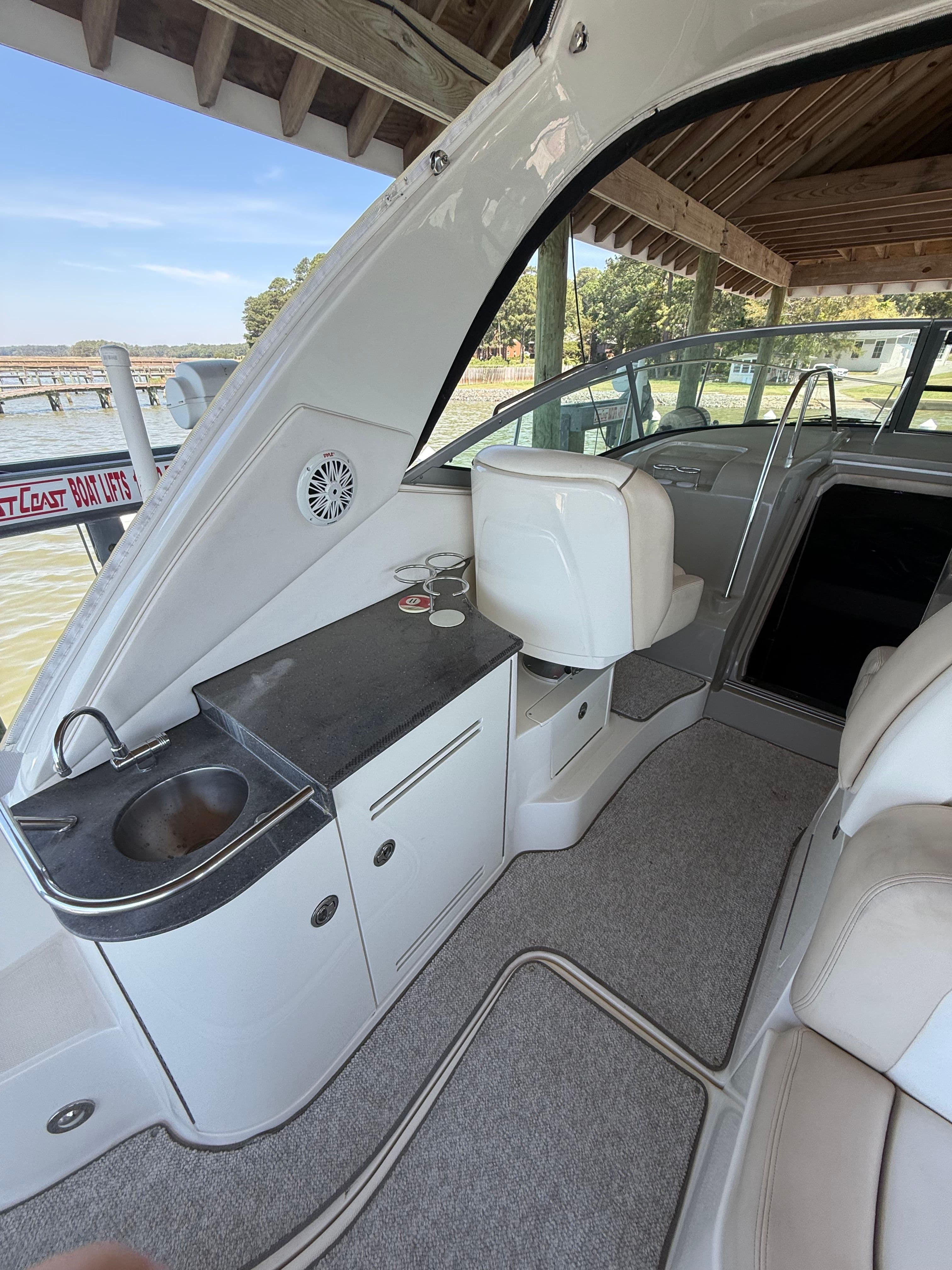 Interior of a 2012 Sea Ray Sundancer 350 yacht with sink and seating area.