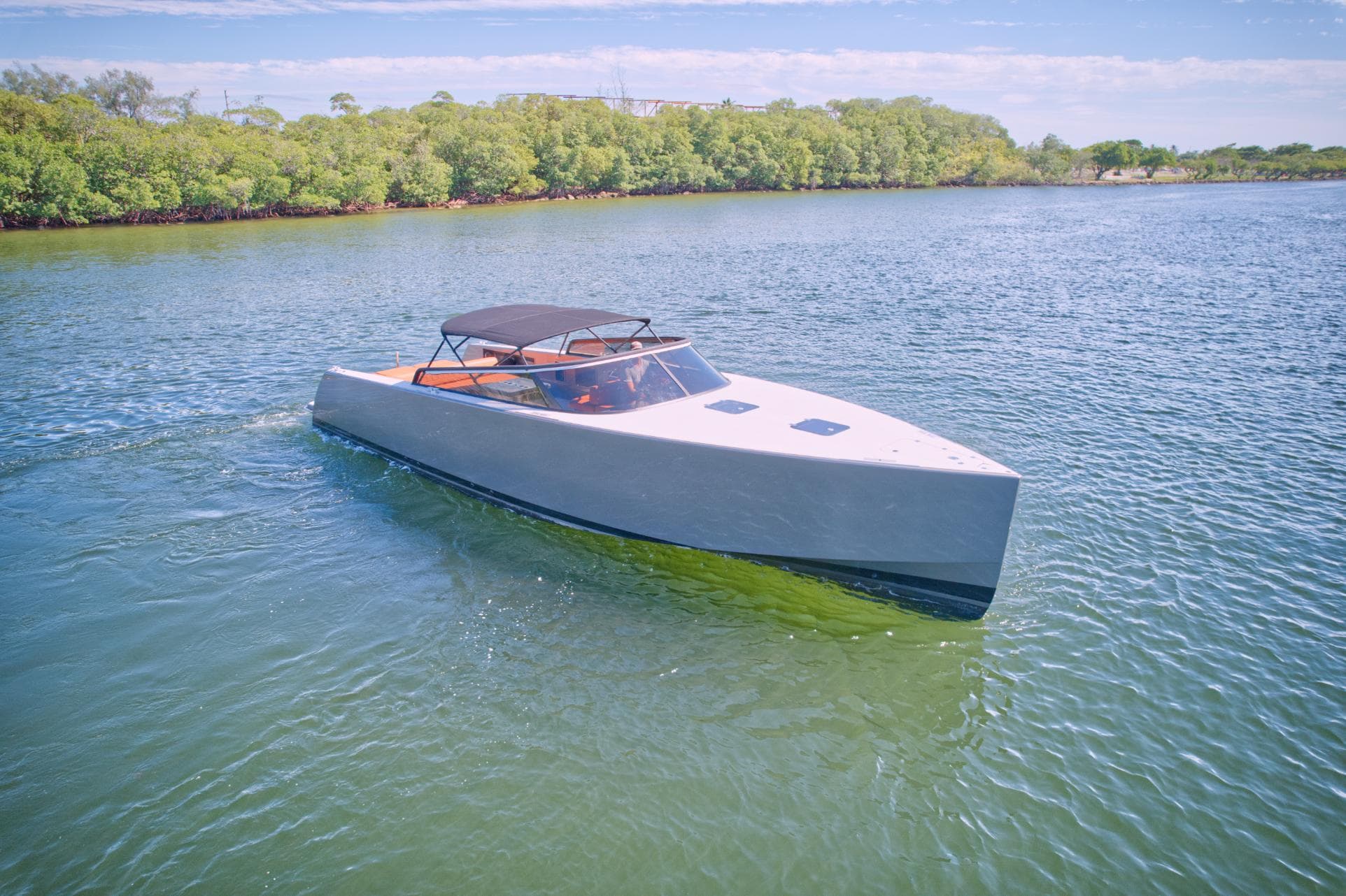 2015 VanDutch 40 luxury yacht cruising on a serene waterway.