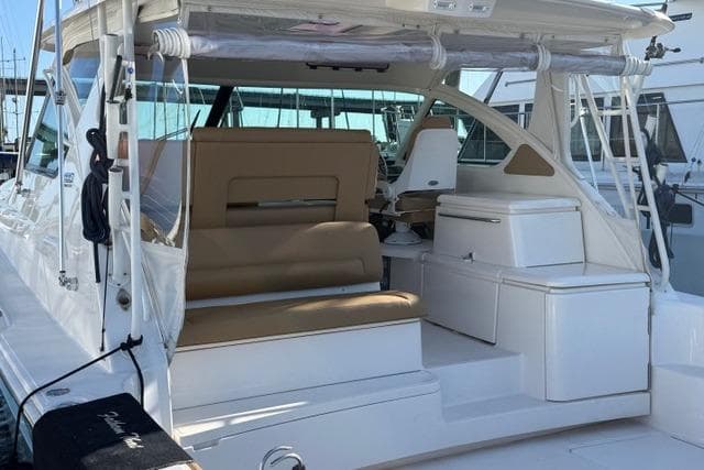 2010 Tiara Yachts 3900 Open with beige seating, docked at a marina.