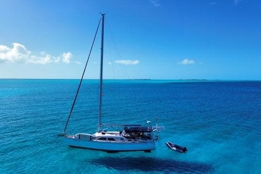 Sailboat Catalina Morgan 440 (2005) anchored in clear blue ocean waters.
