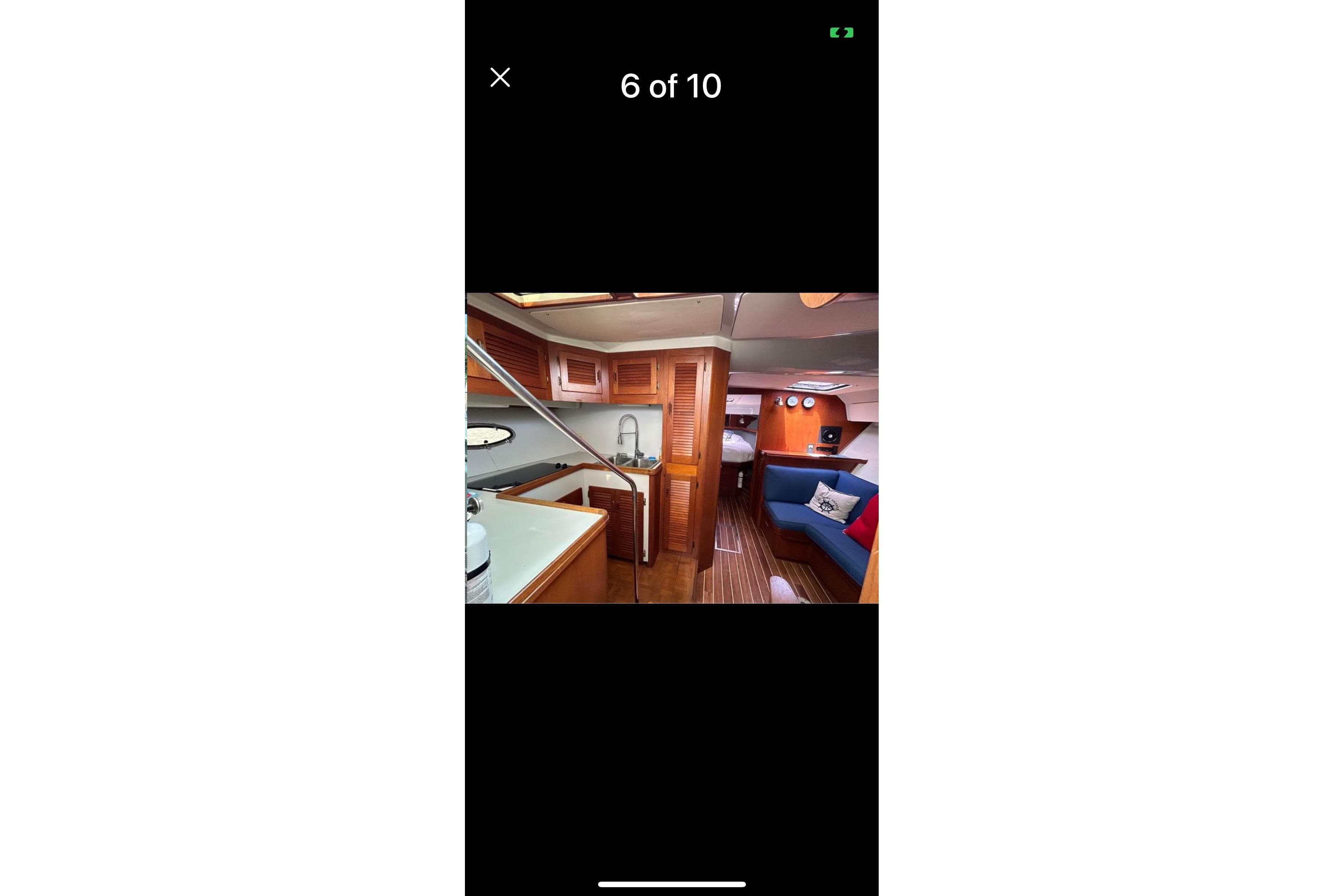 Interior of 1987 Tiara 3600 yacht with wood finishes and cozy seating area.