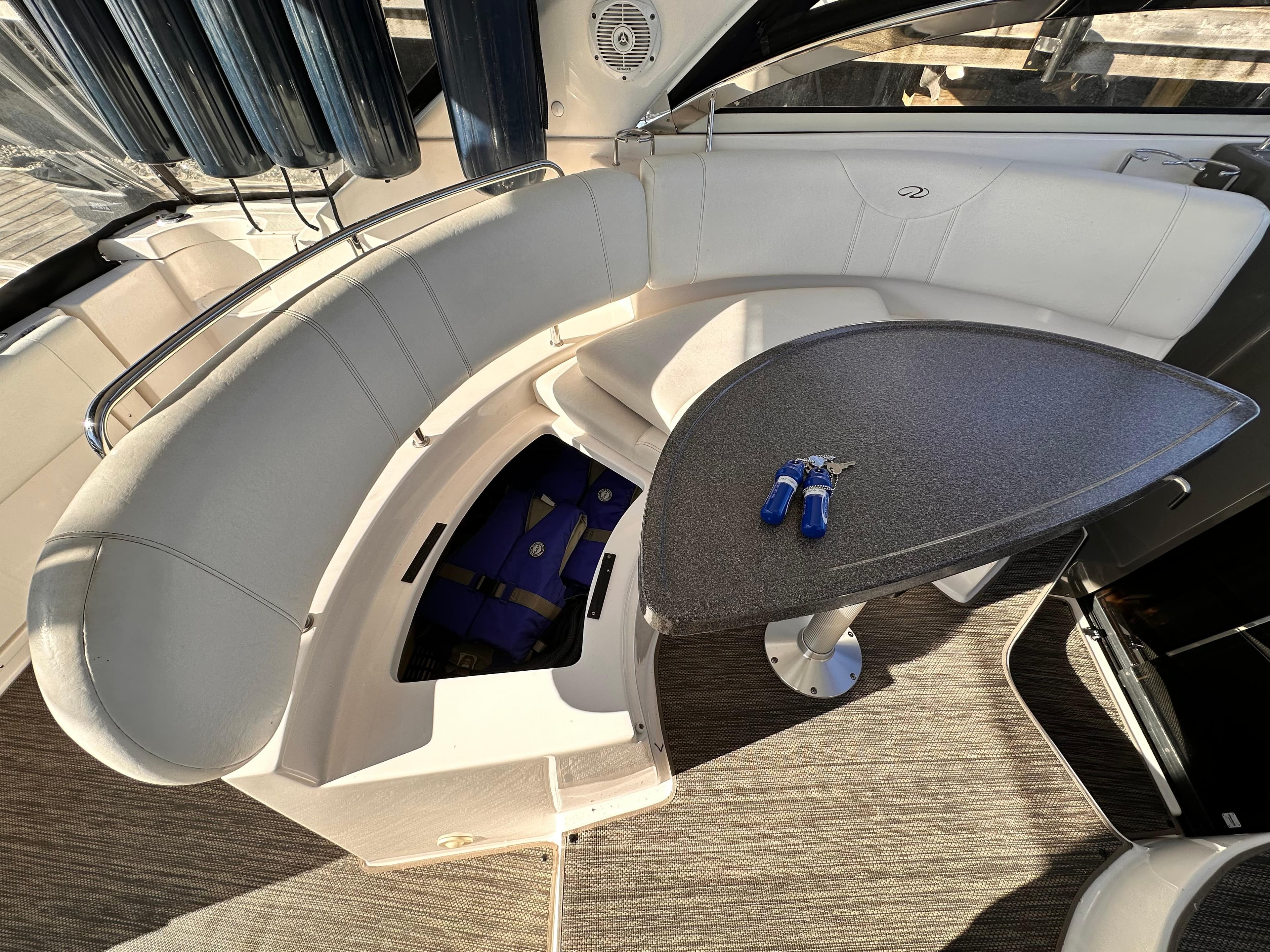 2007 Regal Commodore 3760 IO boat interior with curved seating and table.