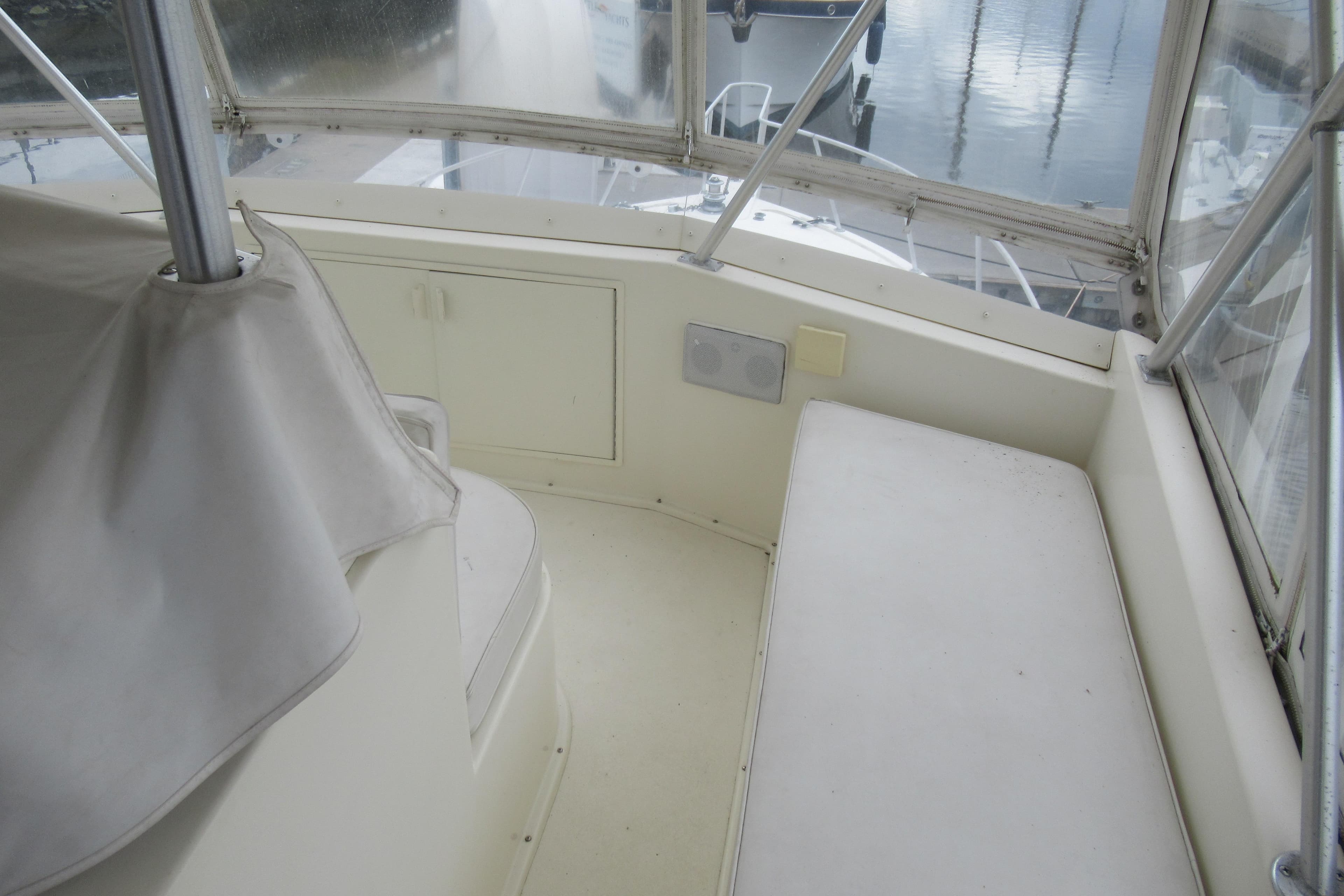 Interior view of a 1990 Viking 38 Convertible boat, featuring seating and storage.