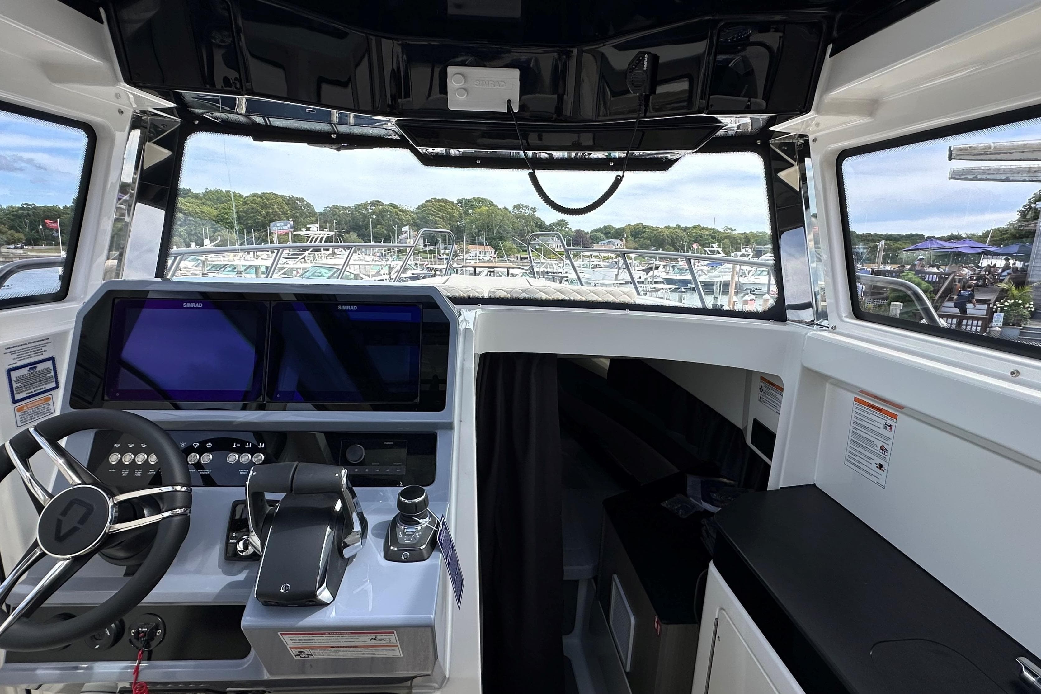 Interior view of 2025 Navan C30 boat cockpit with modern controls and navigation screens.