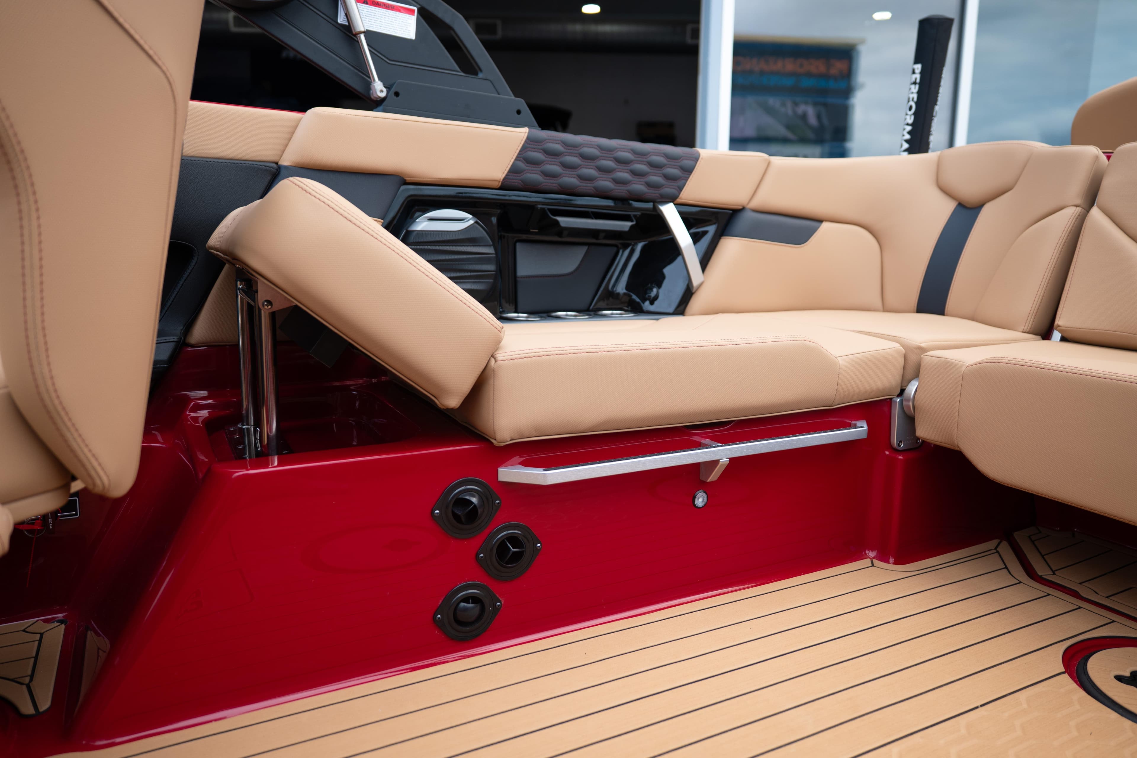 2026 MasterCraft XT23 boat interior with tan seating and red accents.