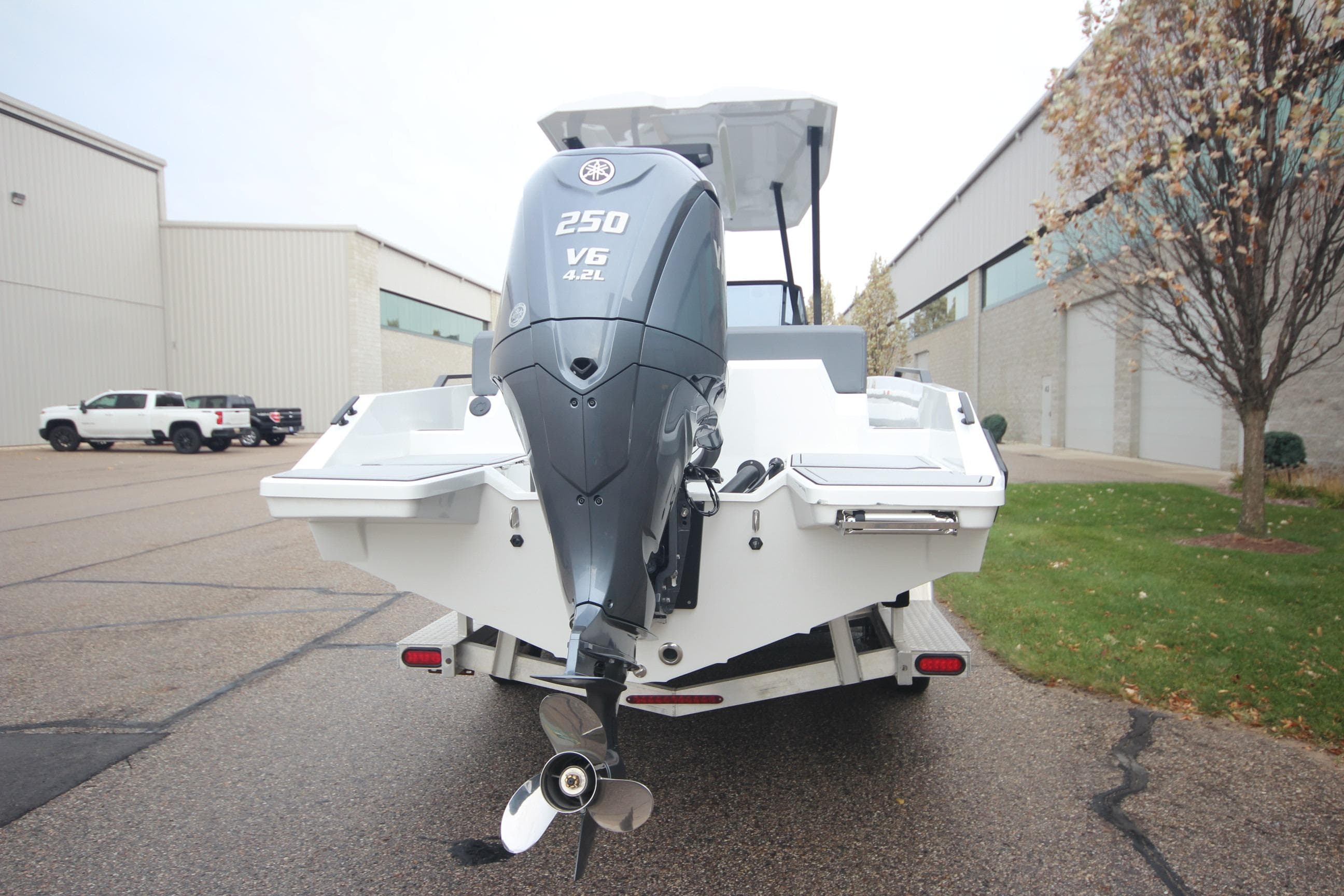 Rear view of Iron 767 boat with powerful V6 engine, parked outdoors.