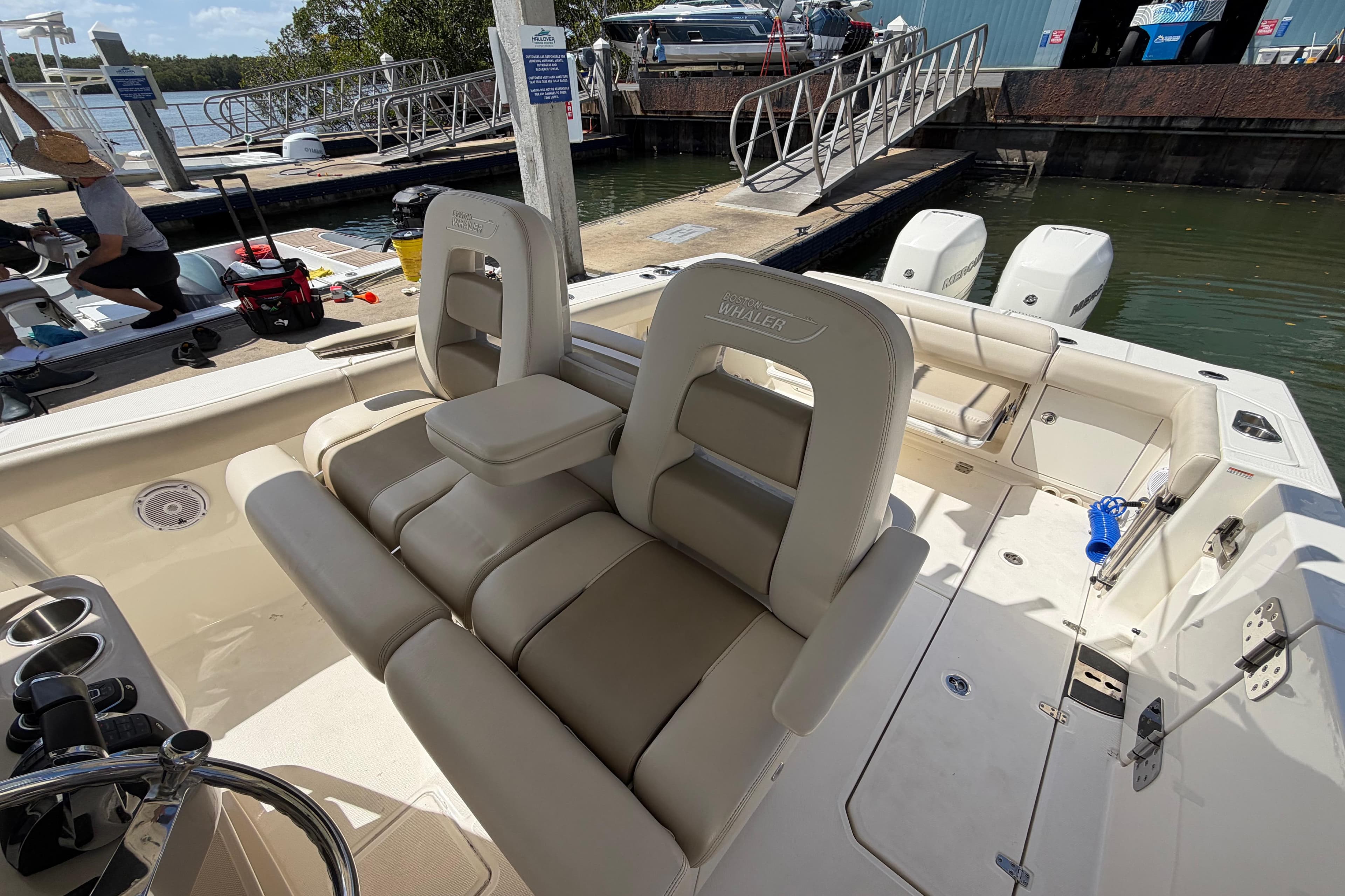 2019 Boston Whaler 330 Outrage boat interior with seating and dock view.