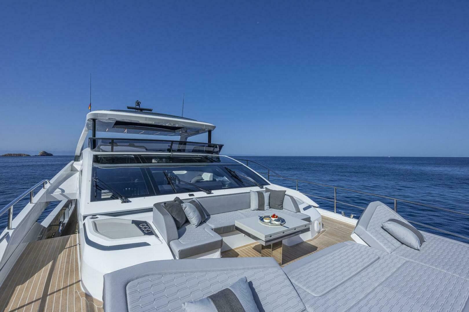 Luxurious 2026 Pearl 82 yacht with elegant deck seating, cruising on a calm ocean.