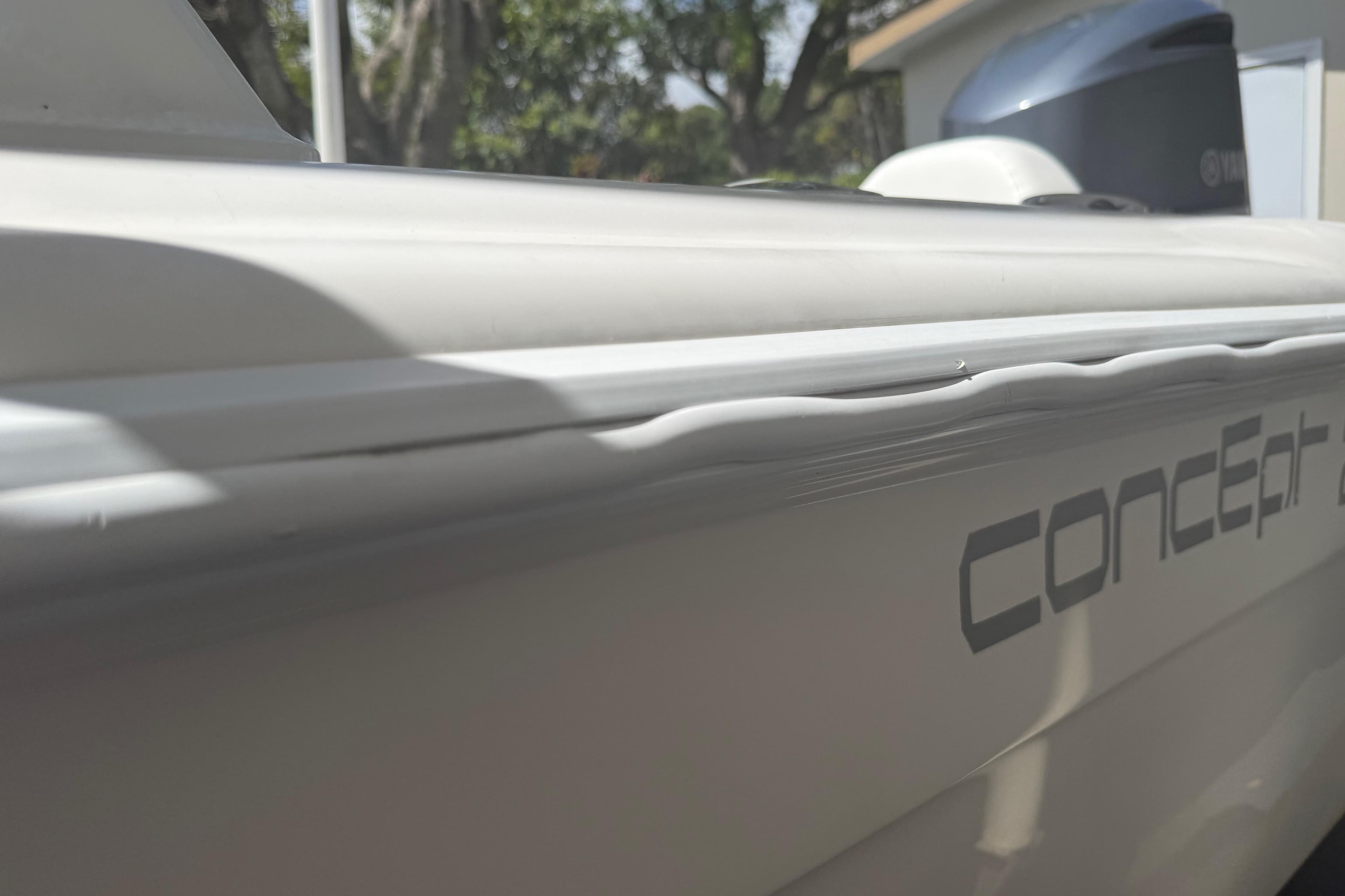 Close-up of a 2015 Concept 27 boat with visible logo and sleek design.