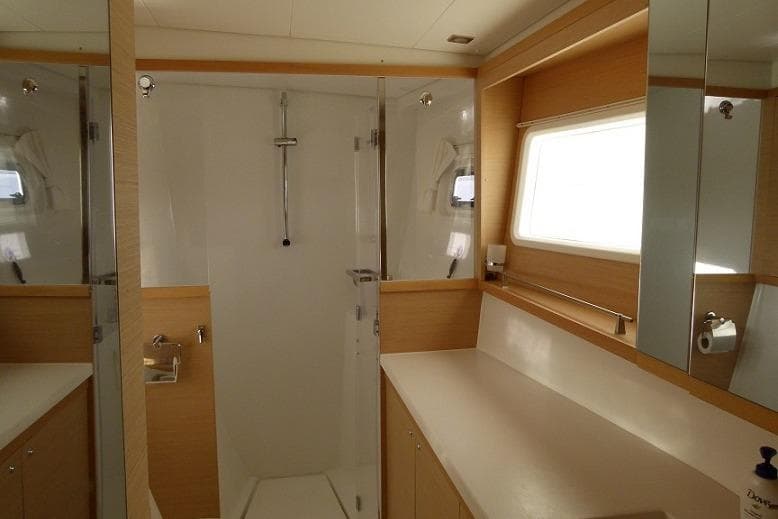 Modern bathroom interior of 2020 Lagoon 450F yacht with shower and vanity.