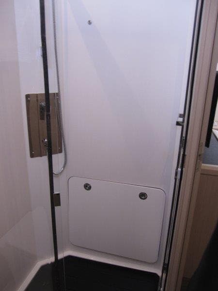 Modern shower area in 2024 Jeanneau 60 yacht with sleek design.