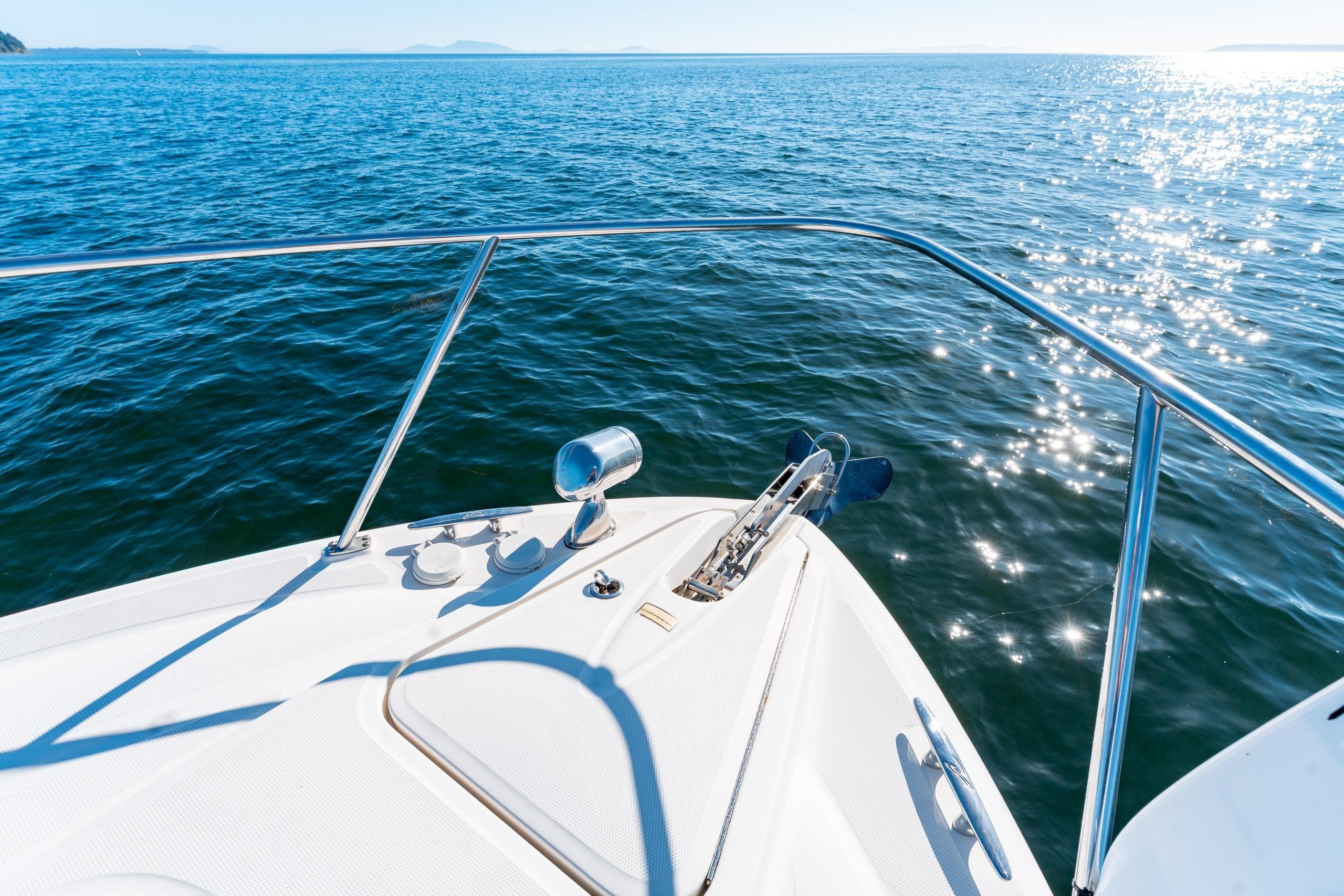 Bow of 2006 Sea Ray 290 Sundancer on sparkling blue water.