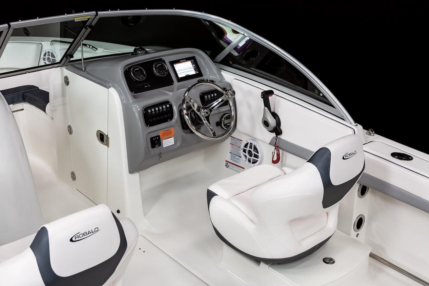 2024 Robalo R207 Dual Console boat interior with steering wheel and seating.