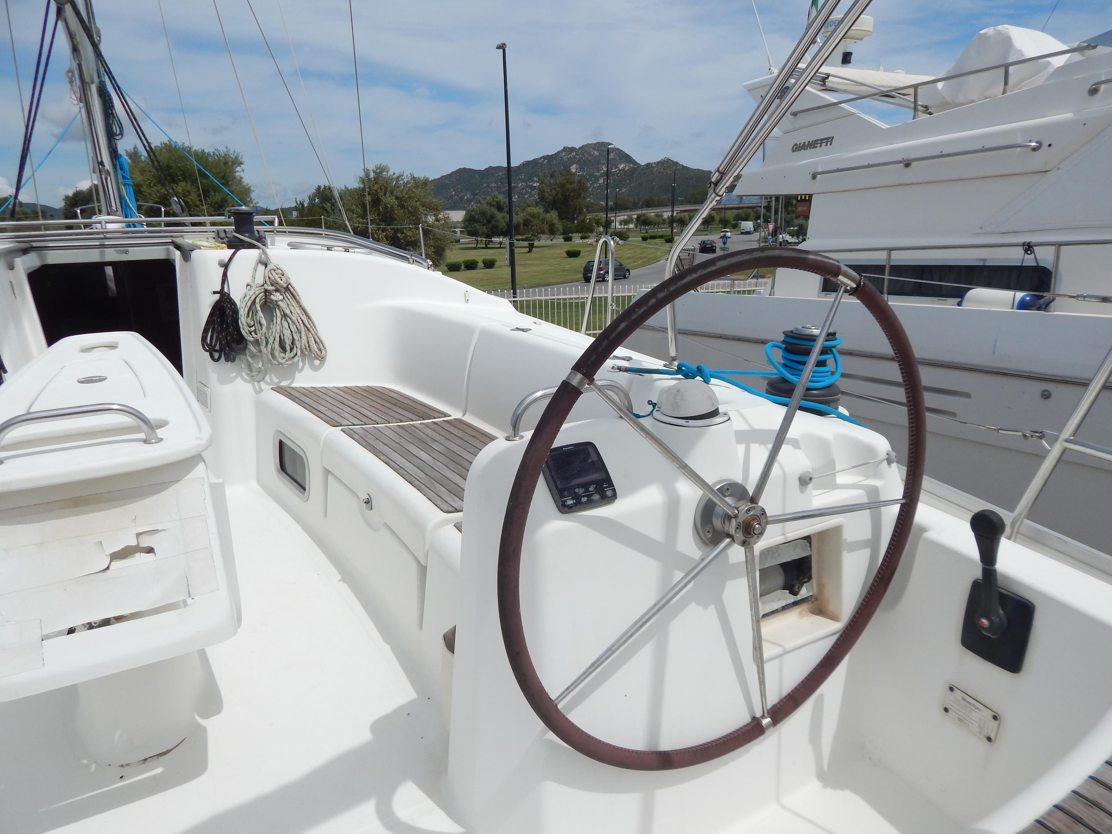 2006 Beneteau Cyclades 43.3 sailboat cockpit with steering wheel and seating area.