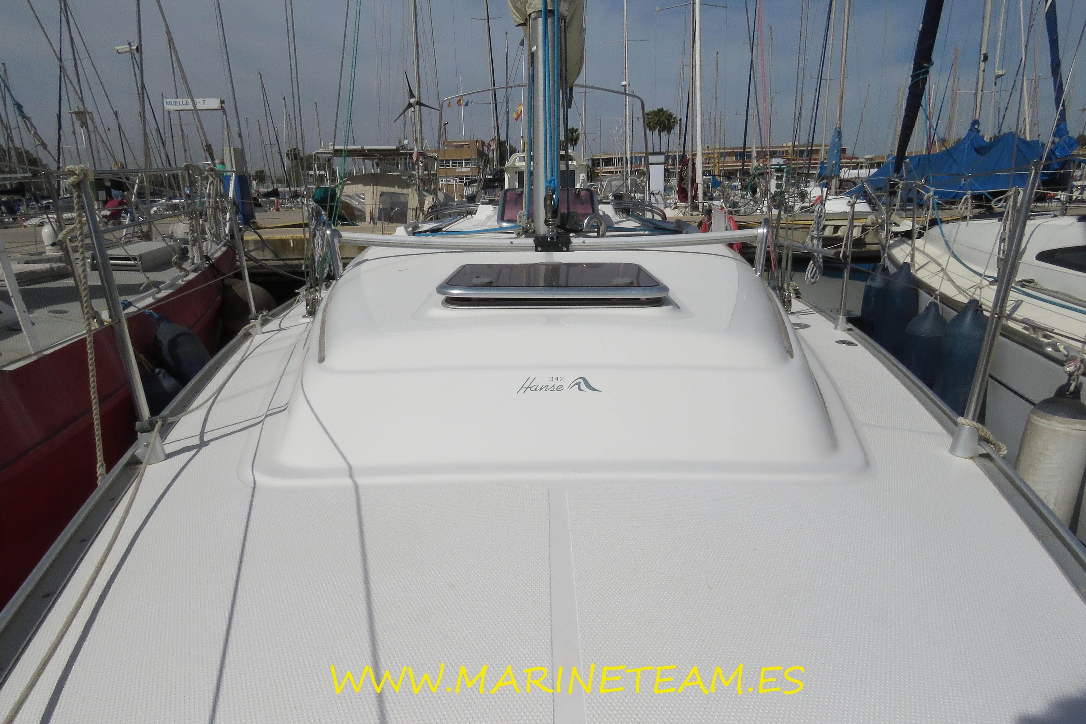 2007 Hanse 342 sailboat docked in a marina, surrounded by other boats.