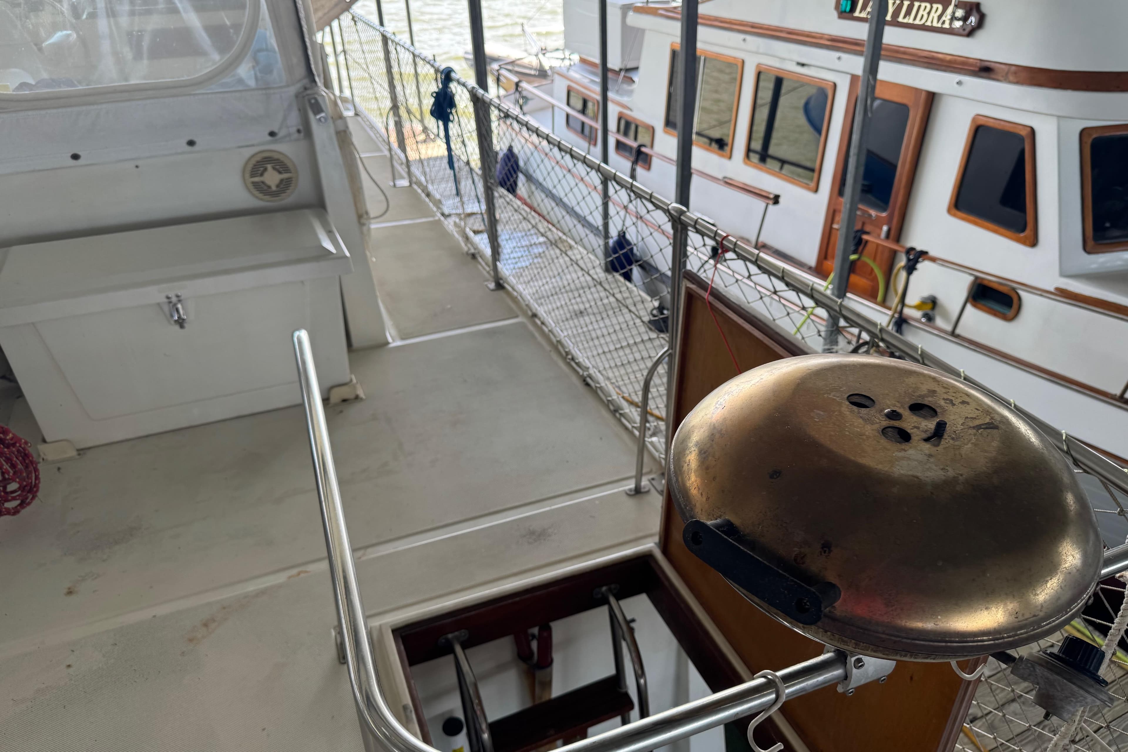Deck view of 1984 Kadey-Krogen 36 Manatee with grill and safety railing.