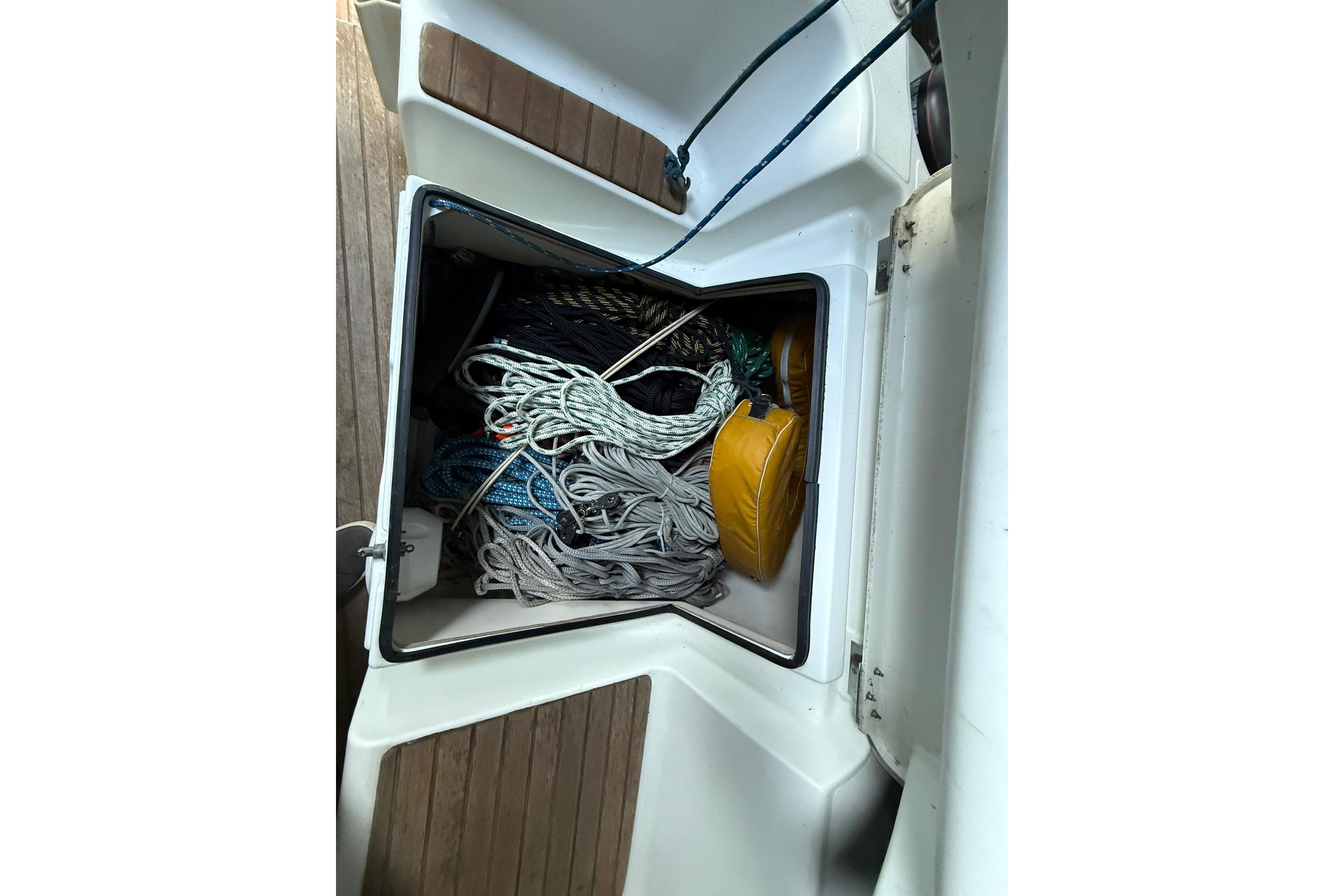 Storage compartment on 2007 Jeanneau Sun Odyssey 39i sailboat with ropes and equipment.