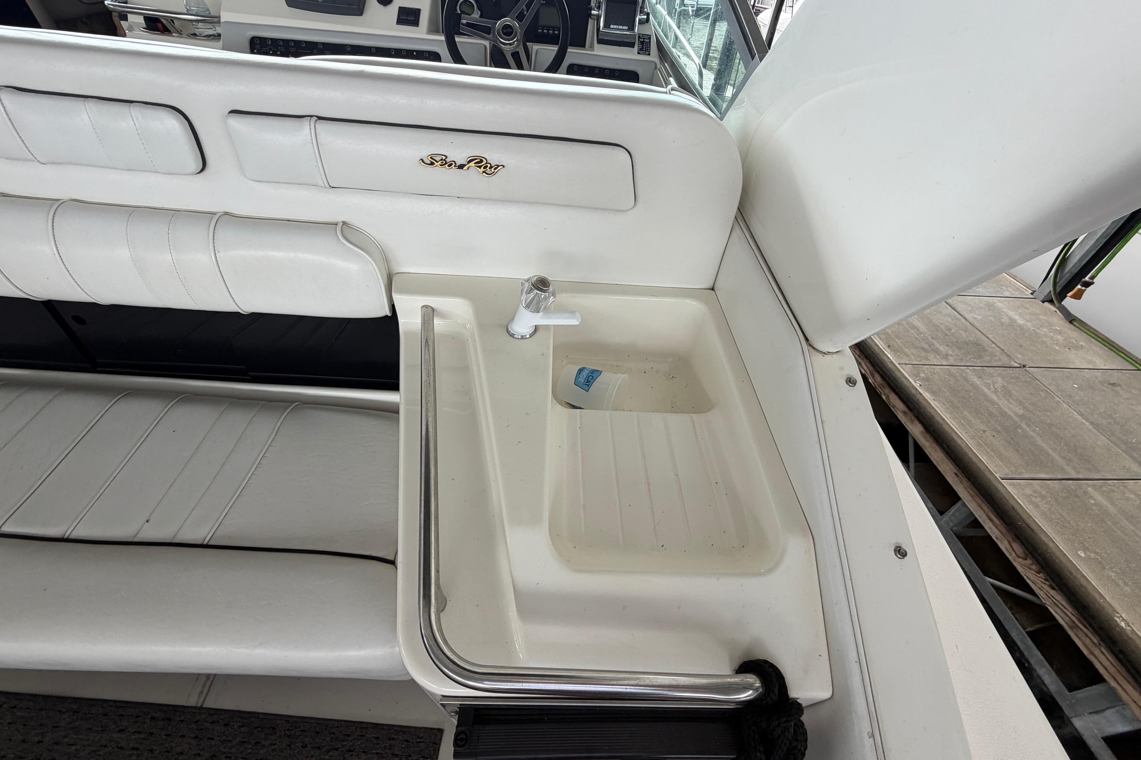 1994 Sea Ray Sundancer 330 boat interior with sink and seating area.