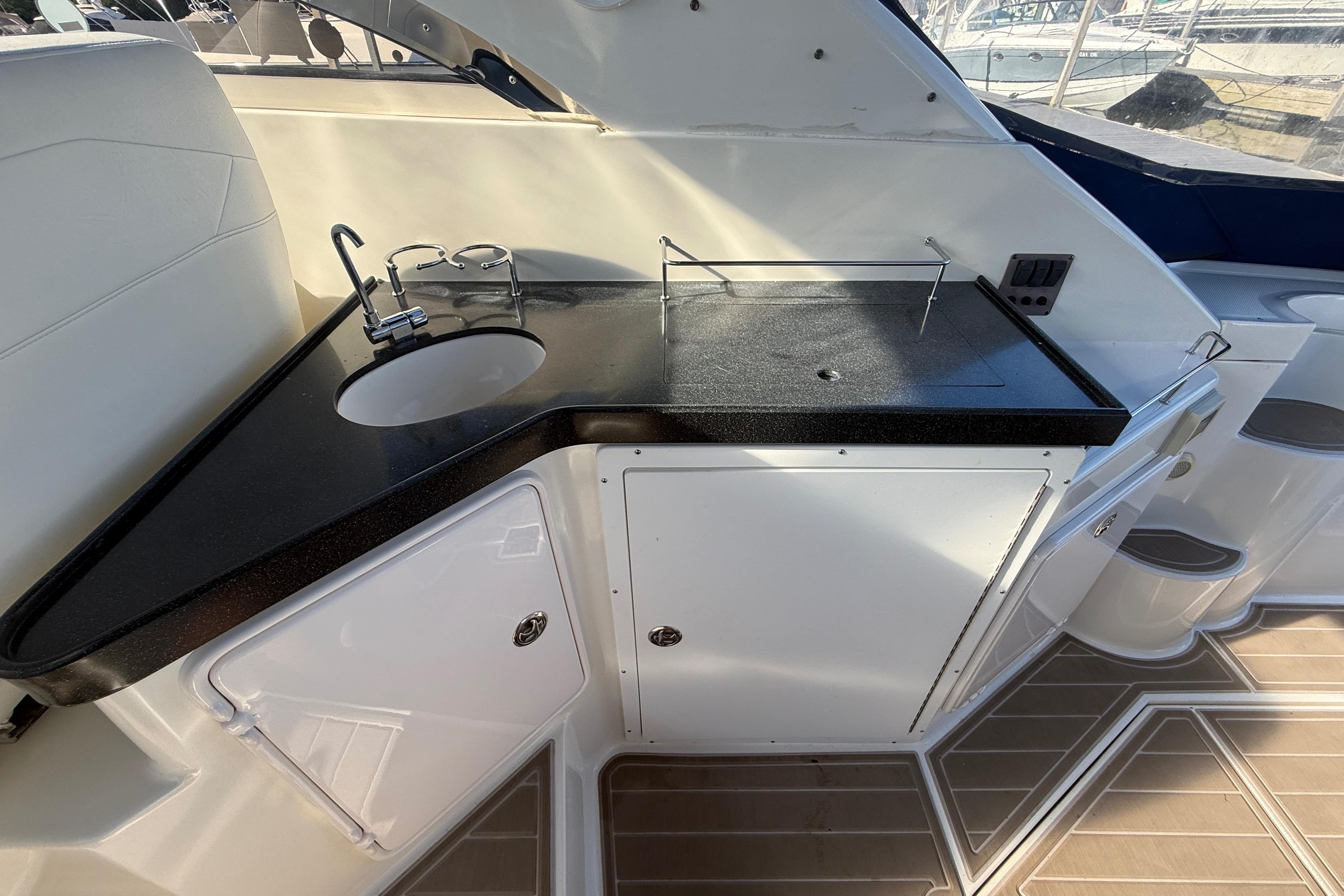 2005 Regal Commodore 3560 IO yacht kitchenette with sink and storage cabinets.