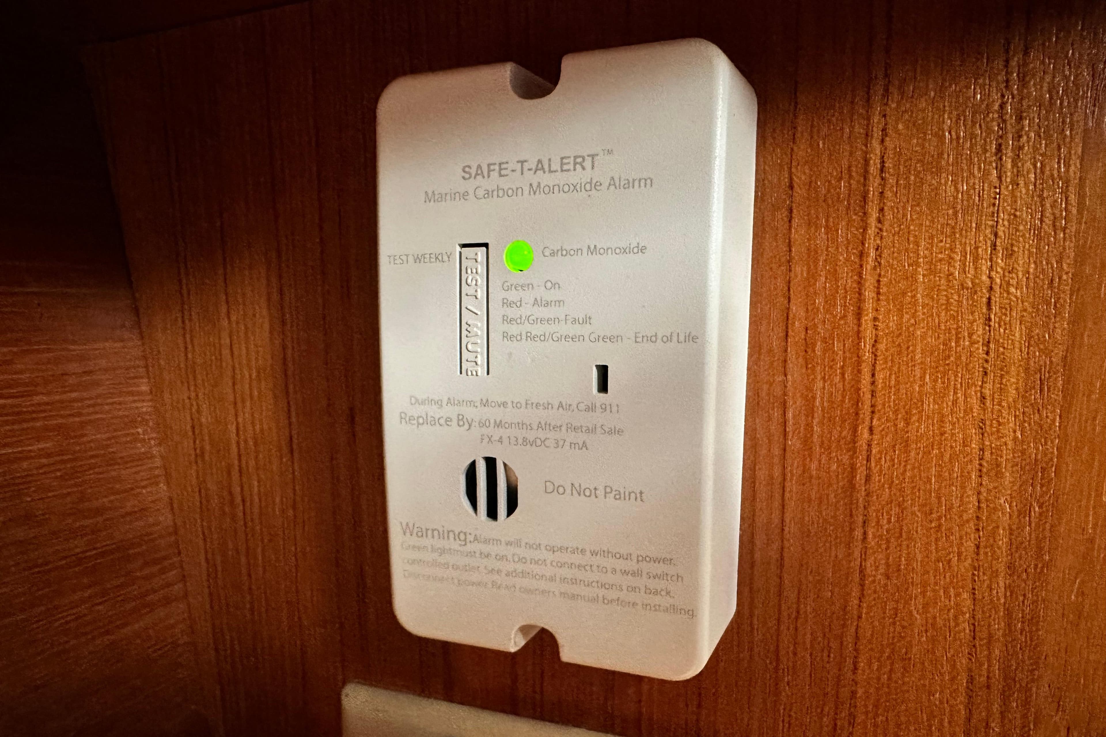 Carbon monoxide alarm on 2005 Hunter 41 AC boat, mounted on wooden panel.