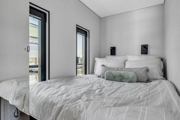 Modern bedroom interior in La Mare Modern 11, 2024 model, with minimalist design and cozy bedding.
