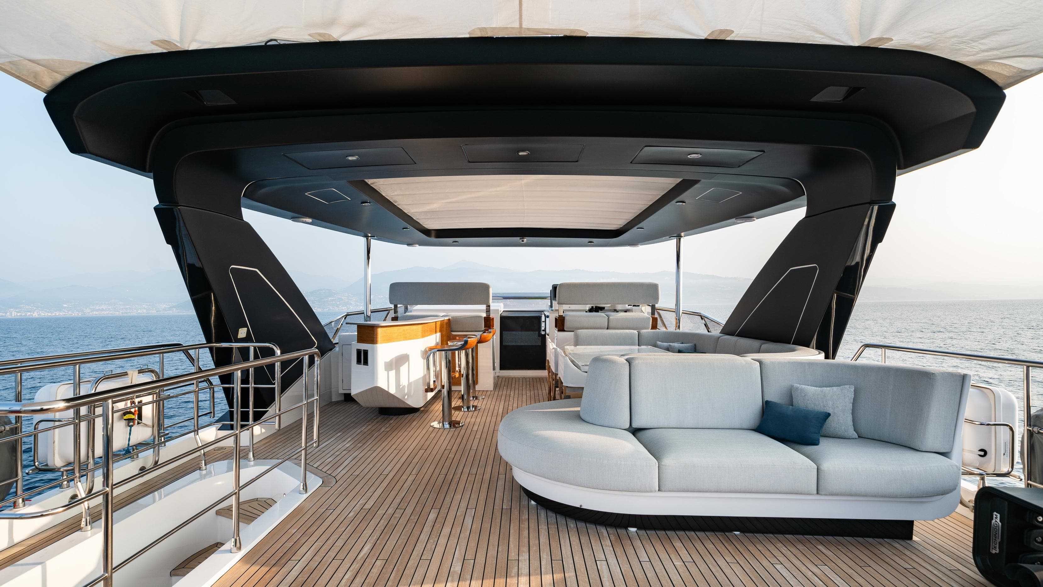Luxurious Azimut Grande 27 METRI yacht deck with elegant seating, ocean view, 2020 model.
