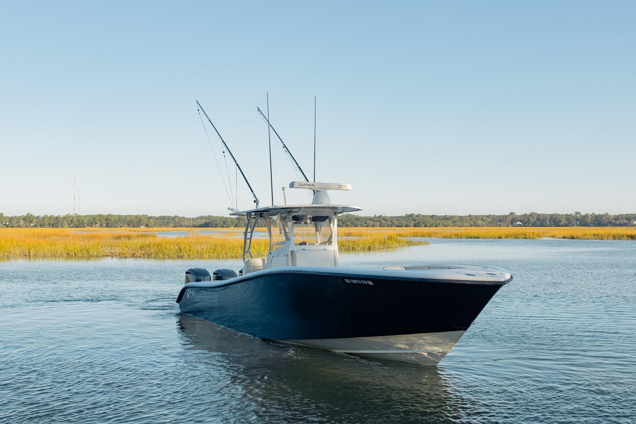 2014 Yellowfin 34 Offshore boat on calm water, surrounded by marshland.