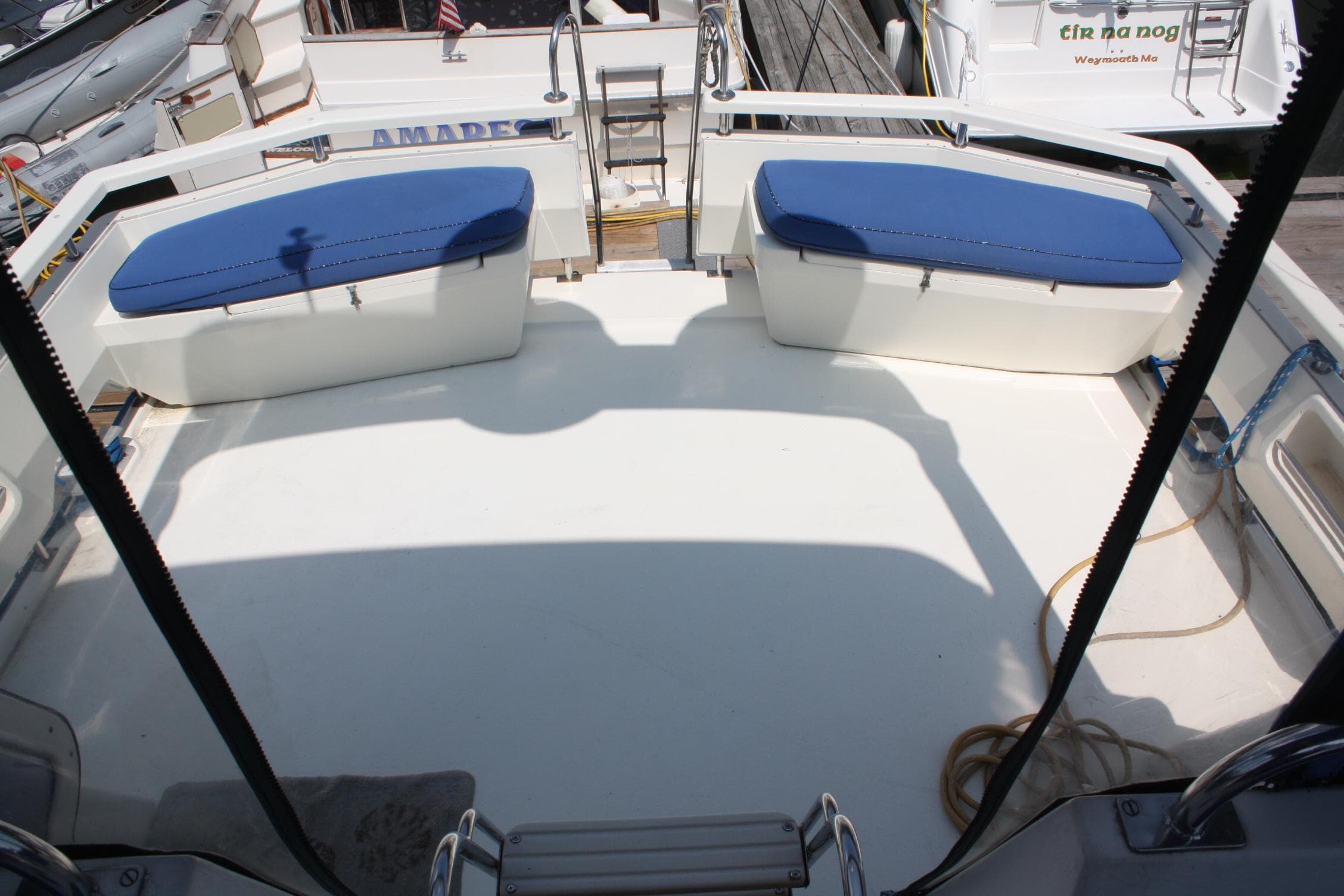 1986 Birchwood 42 Empress yacht deck with blue cushioned seating and dock view.