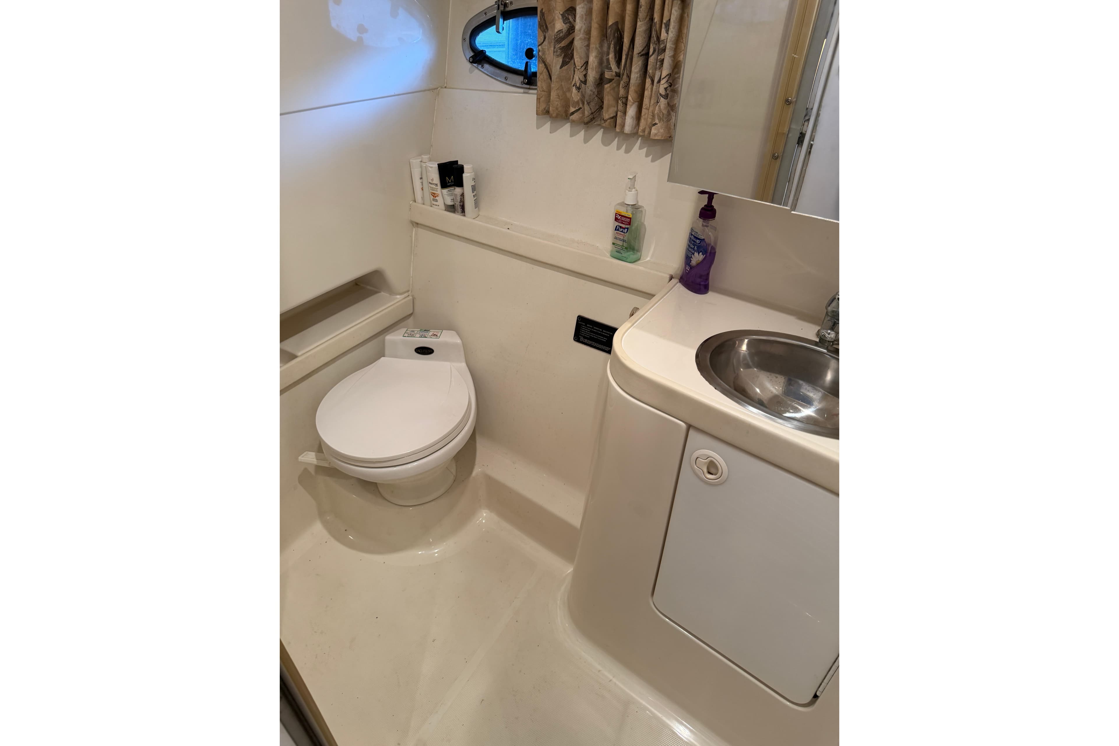 Bathroom interior of 1998 Formula 34 Performance Cruiser with toilet and sink.