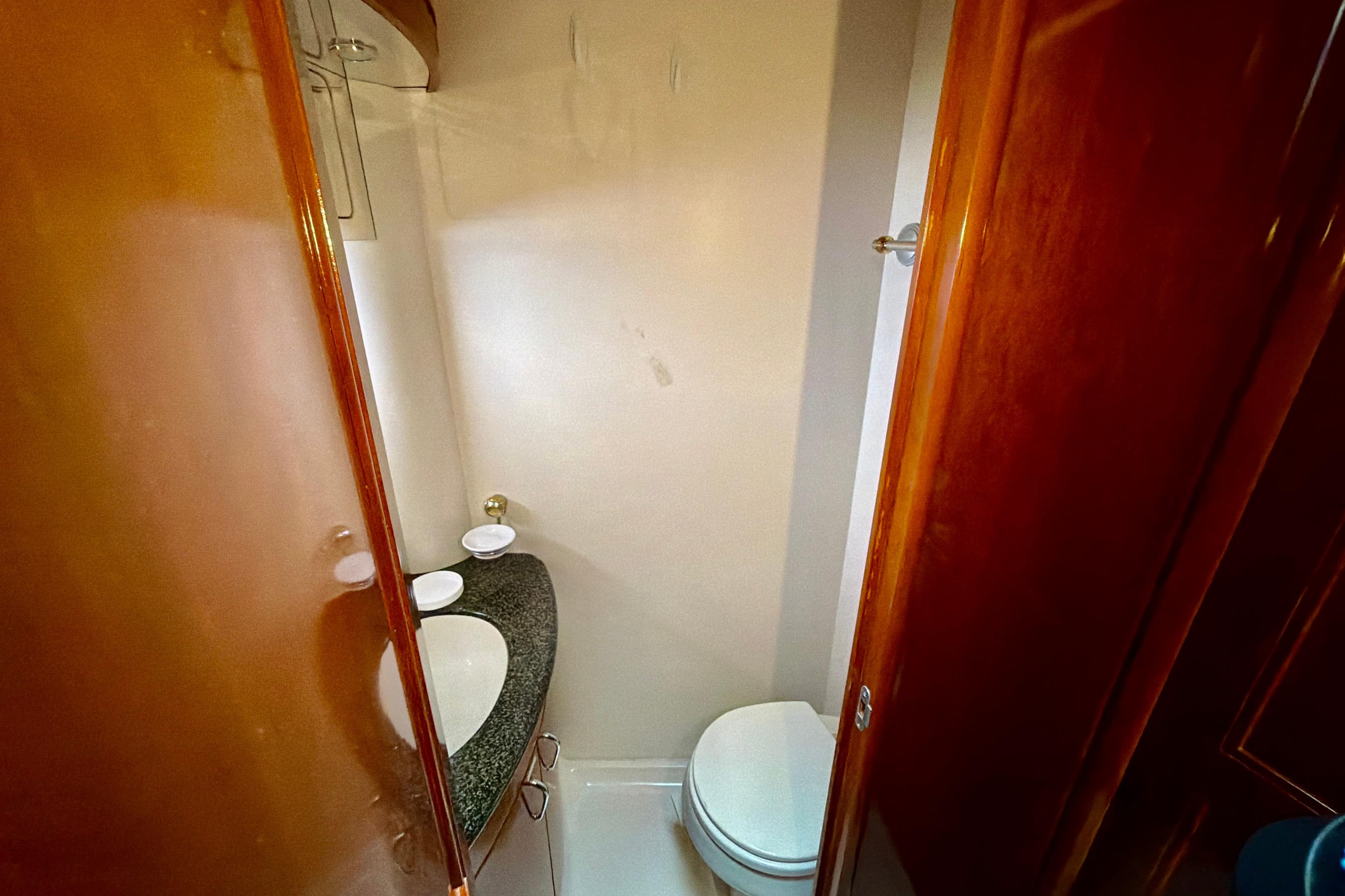 2003 Carver 564 Cockpit Motor Yacht bathroom with sink and toilet.