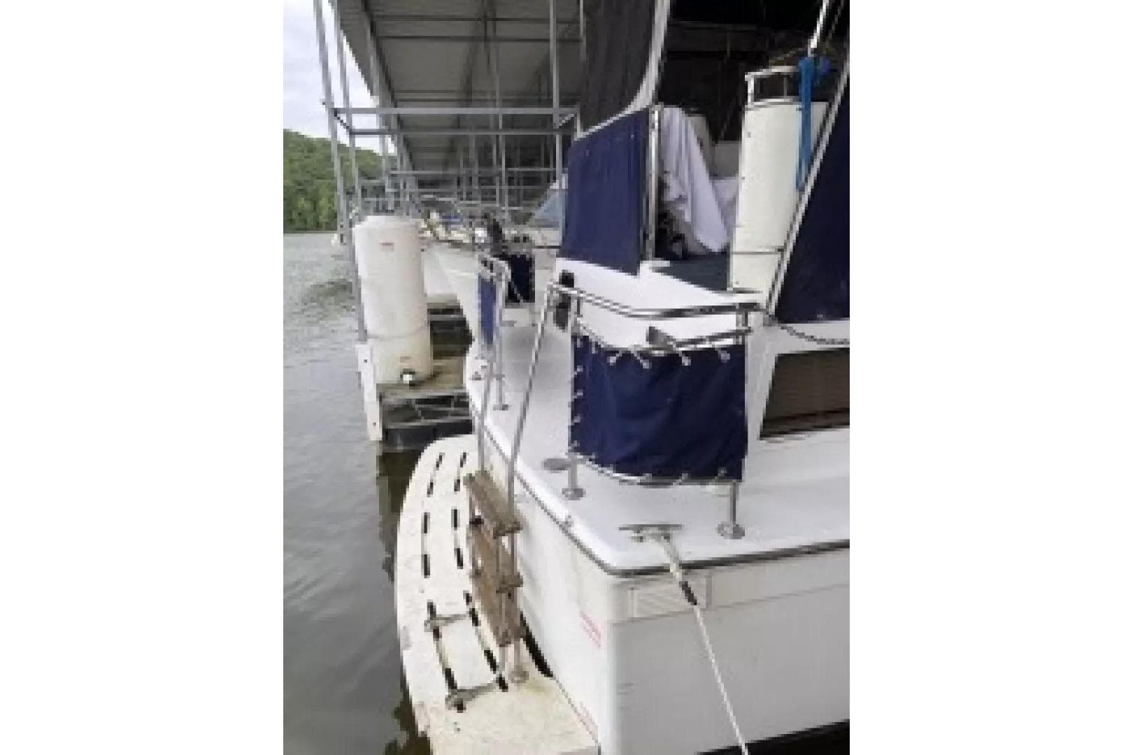 1979 Chris-Craft 350 Catalina docked, featuring blue canvas covers and swim platform.