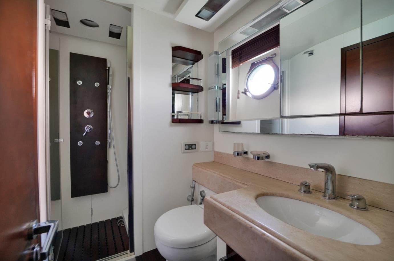Luxurious bathroom in 2009 Azimut 75 yacht with modern fixtures and porthole window.