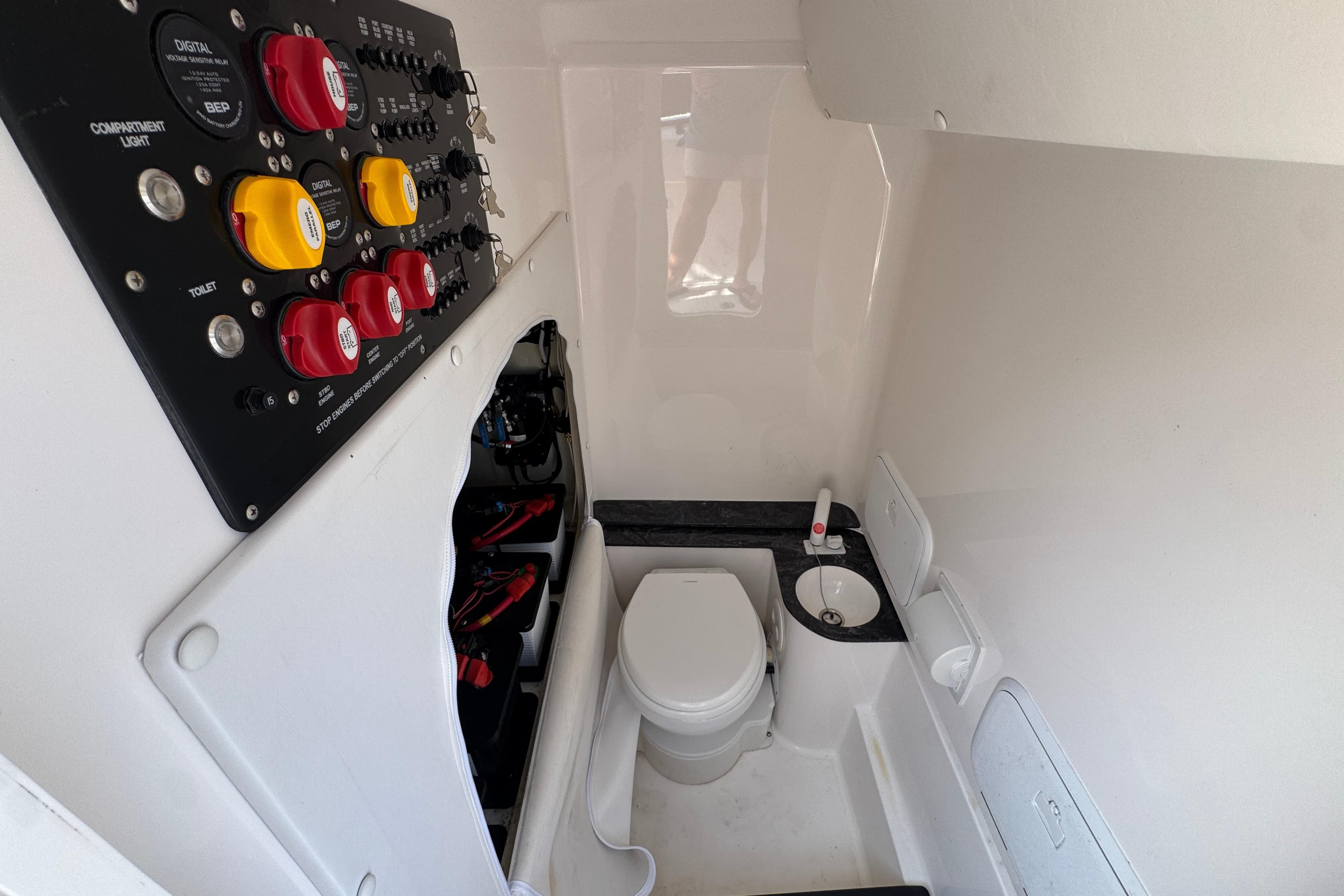 2024 Fountain Bluewater 38 Tournament Edition boat interior with control panel and compact bathroom.