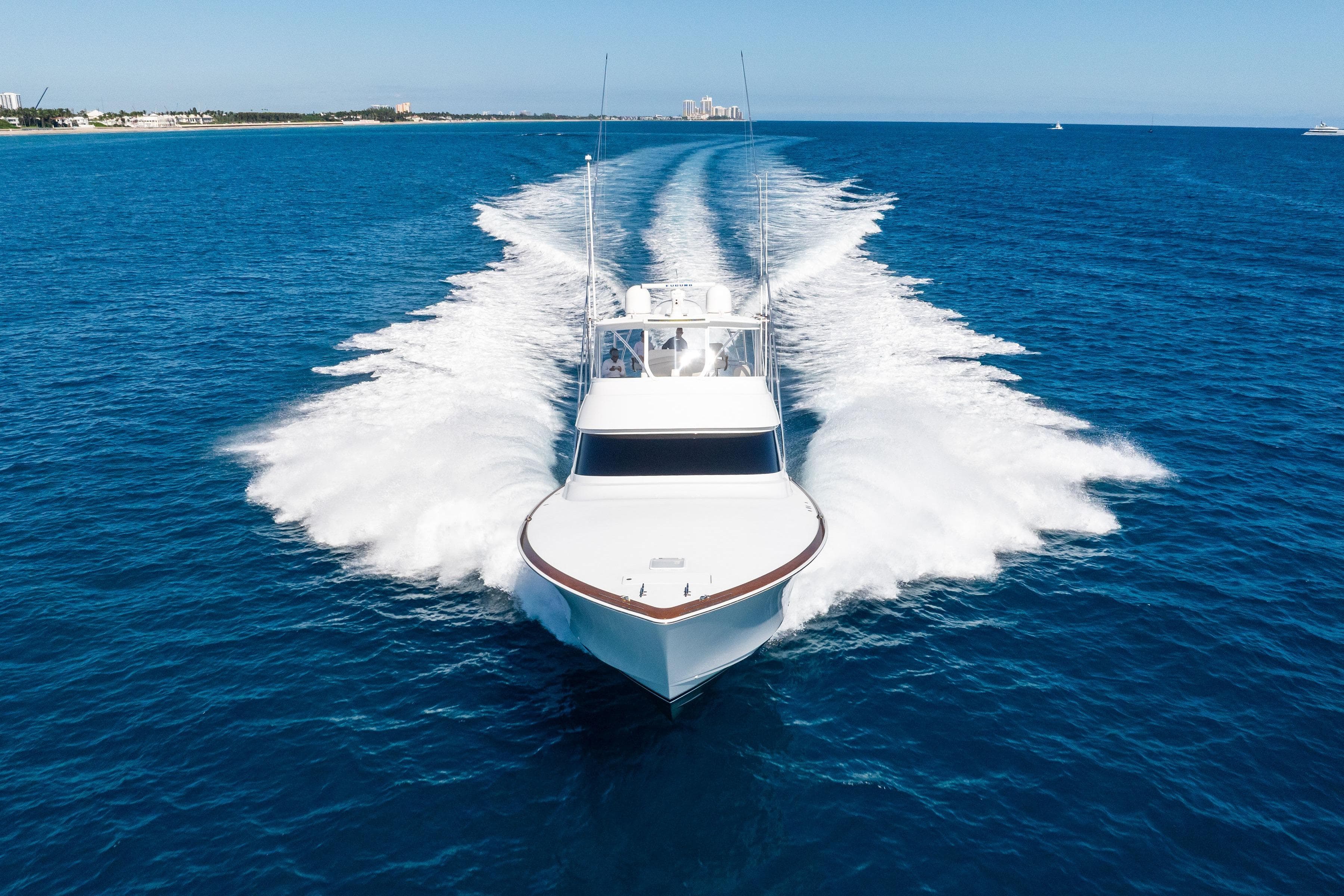 2025 Viking 64 Convertible yacht cruising on open blue ocean waters.