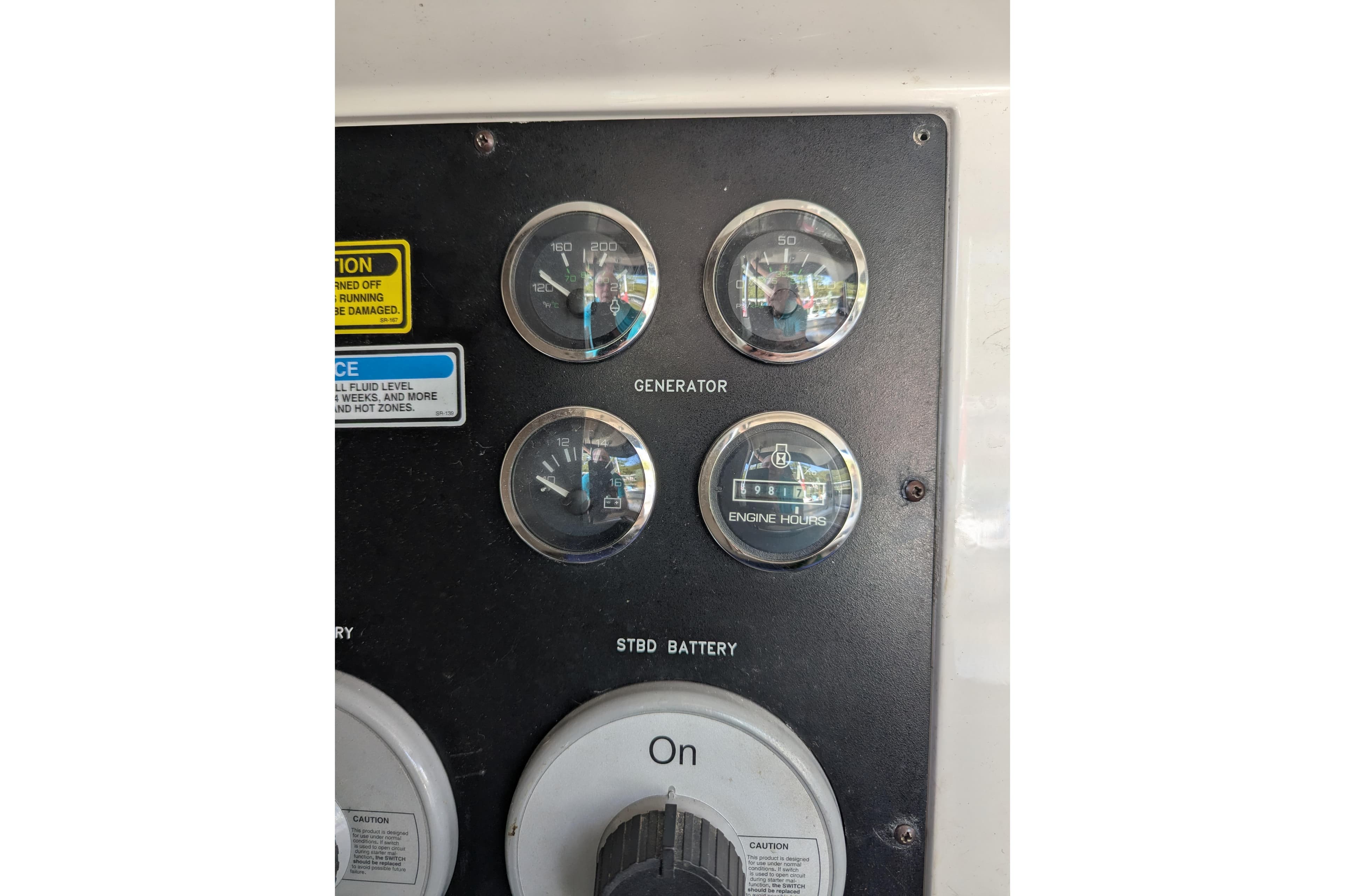 Control panel of a 1998 Sea Ray 480 Sedan Bridge with gauges and switches.