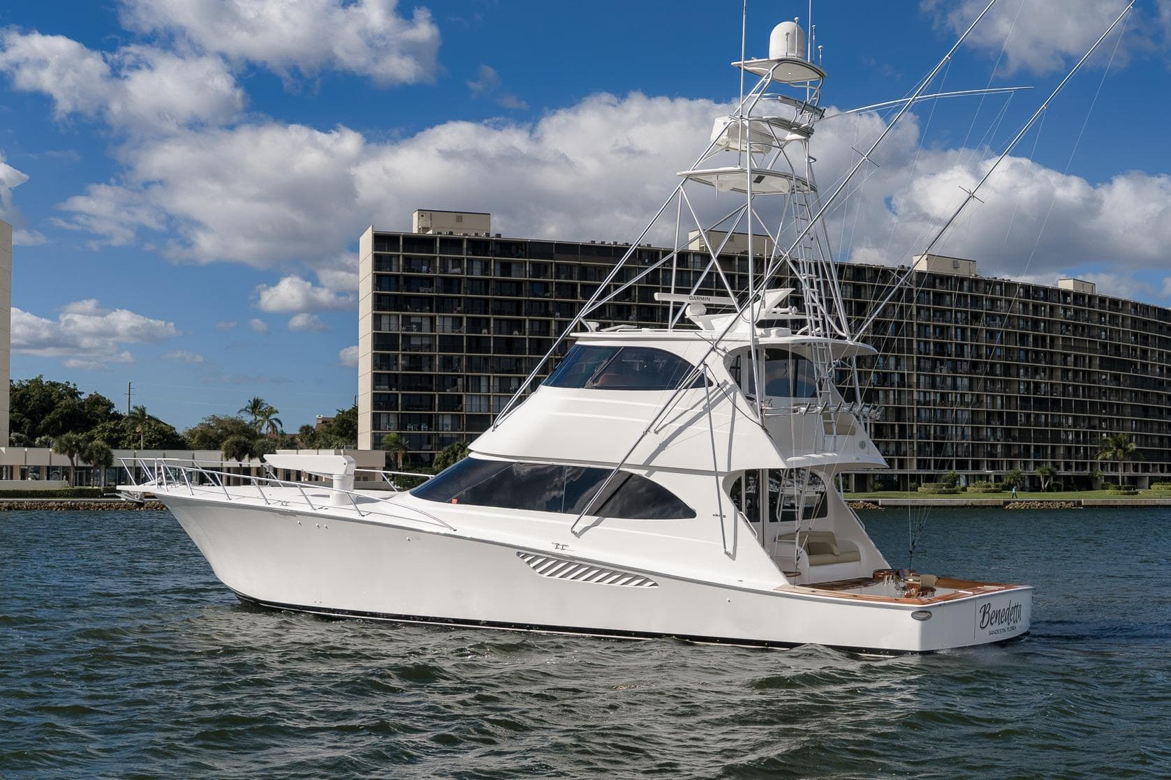 2012 Viking 70 Enclosed Bridge yacht on water, with cityscape background.