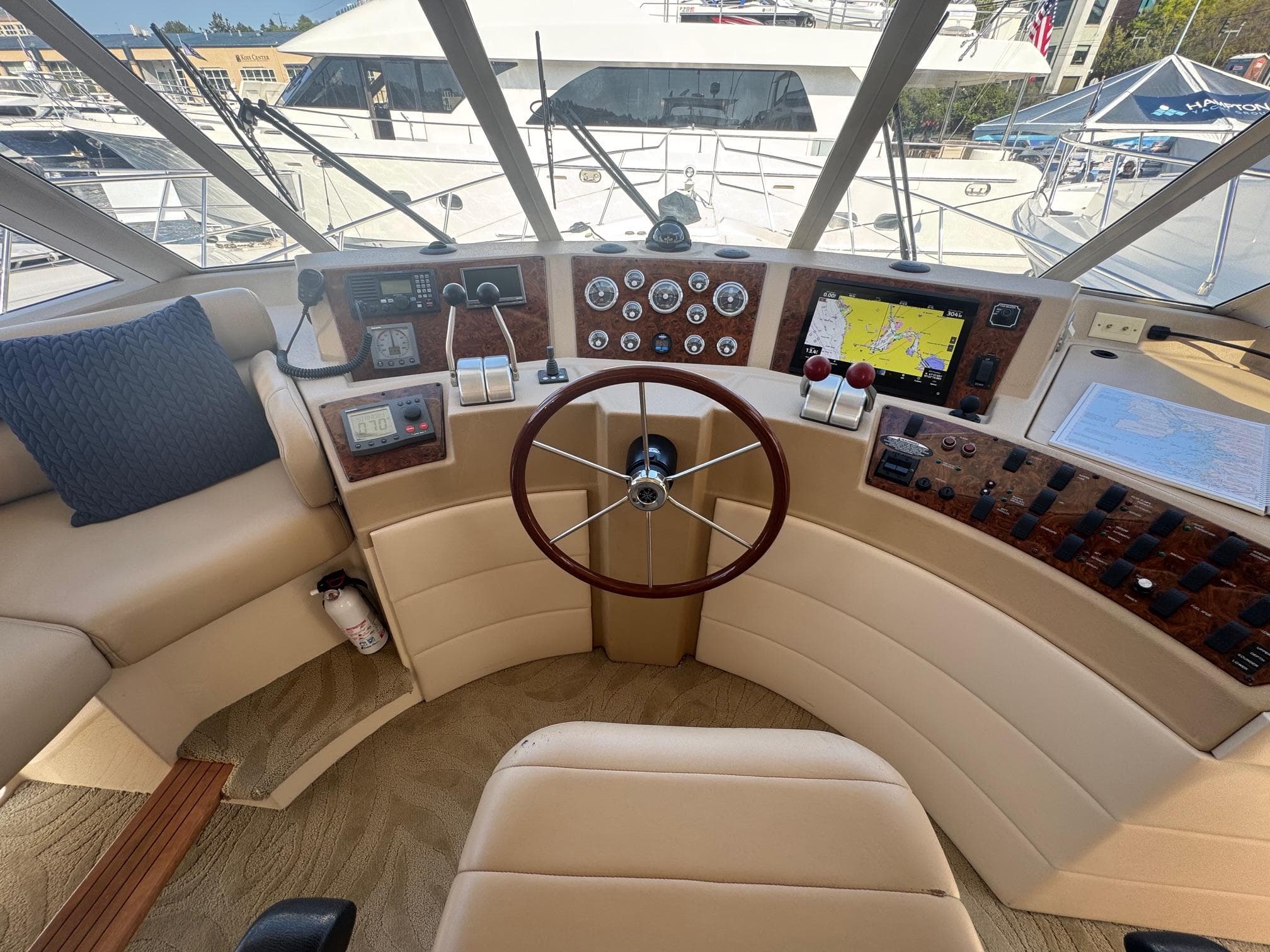 Pilothouse of 2004 Meridian 490 yacht with steering wheel and navigation instruments.