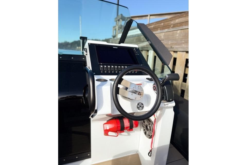 Steering console of 2025 Goldfish 30 Sport boat with modern controls and navigation display.