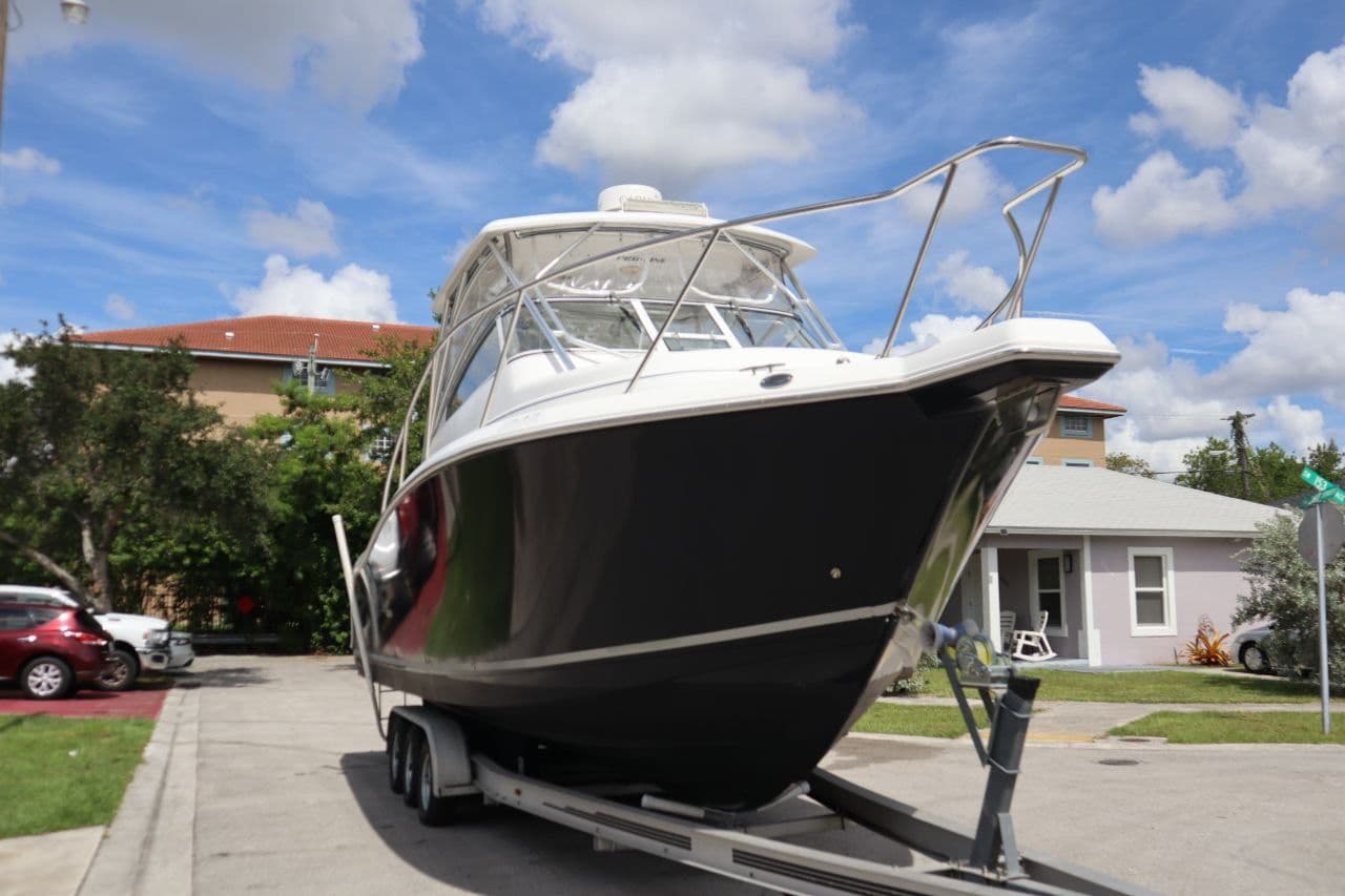 2007 Pro-Line 32 Express boat on trailer, blue sky.