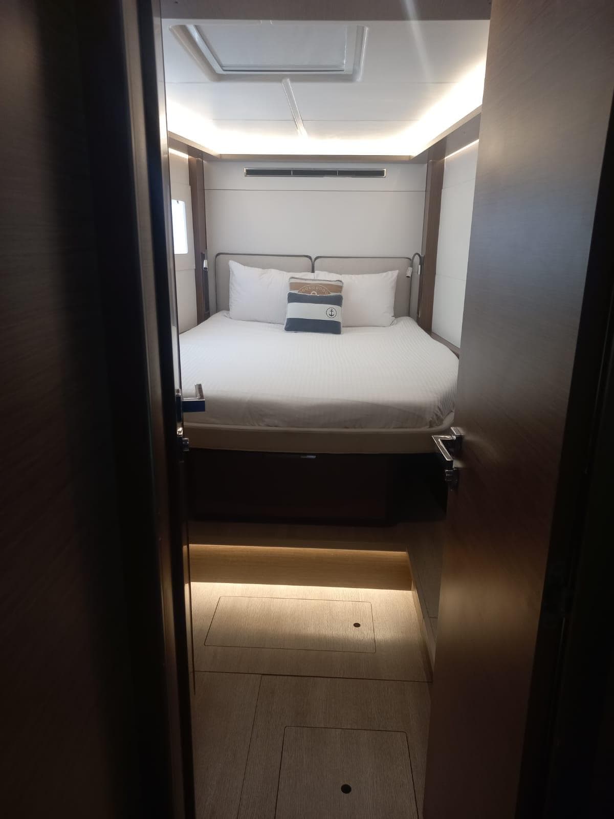 Interior cabin of 2020 Lagoon 46 yacht with modern design and cozy bedding.