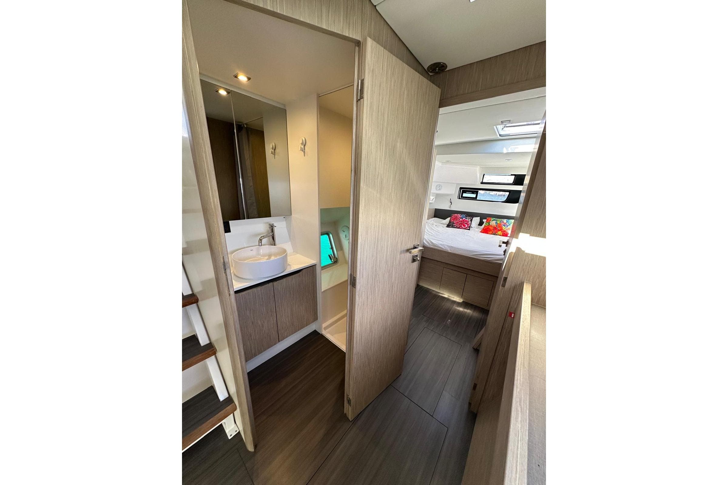 Modern interior of 2021 Outremer 55 yacht featuring bathroom and cozy bedroom.