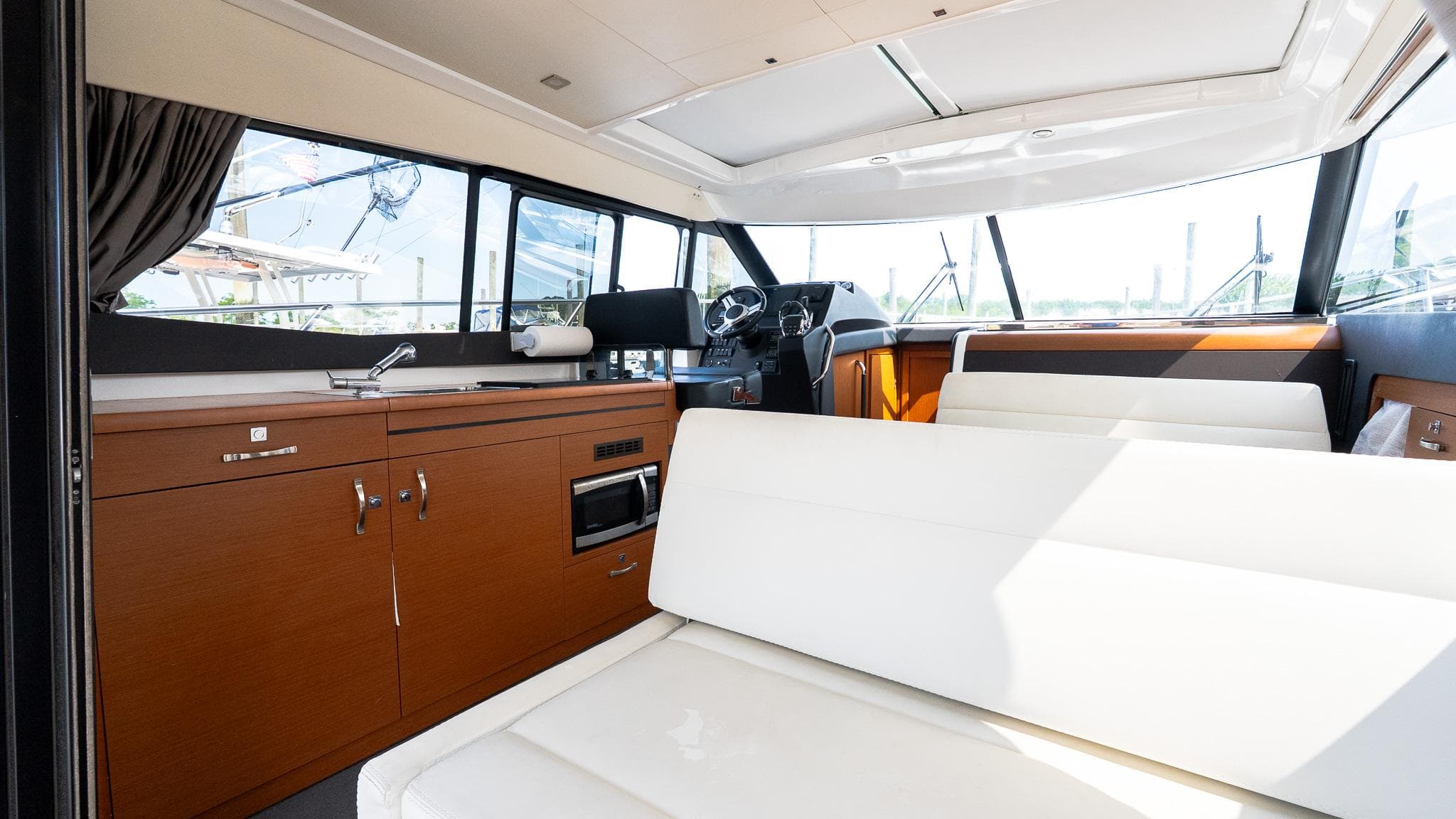 Interior of 2018 Jeanneau NC11 yacht with modern seating and kitchen area.